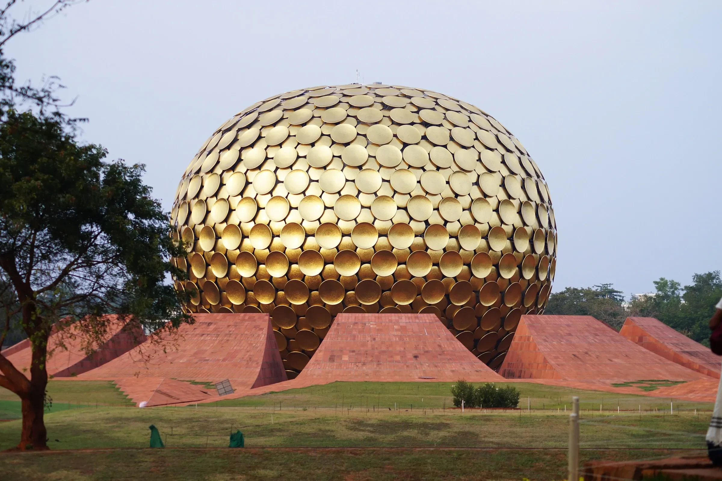 The Matrimandir's golden sphere above its red petal-shaped lawns in Auroville