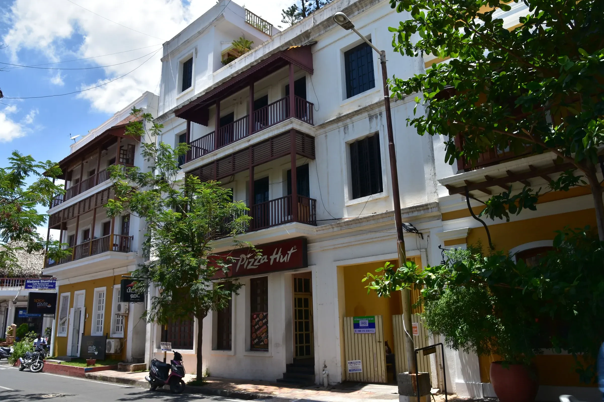 Yellow and white colonial buildings along a street in the French Quarter of Pondicherry