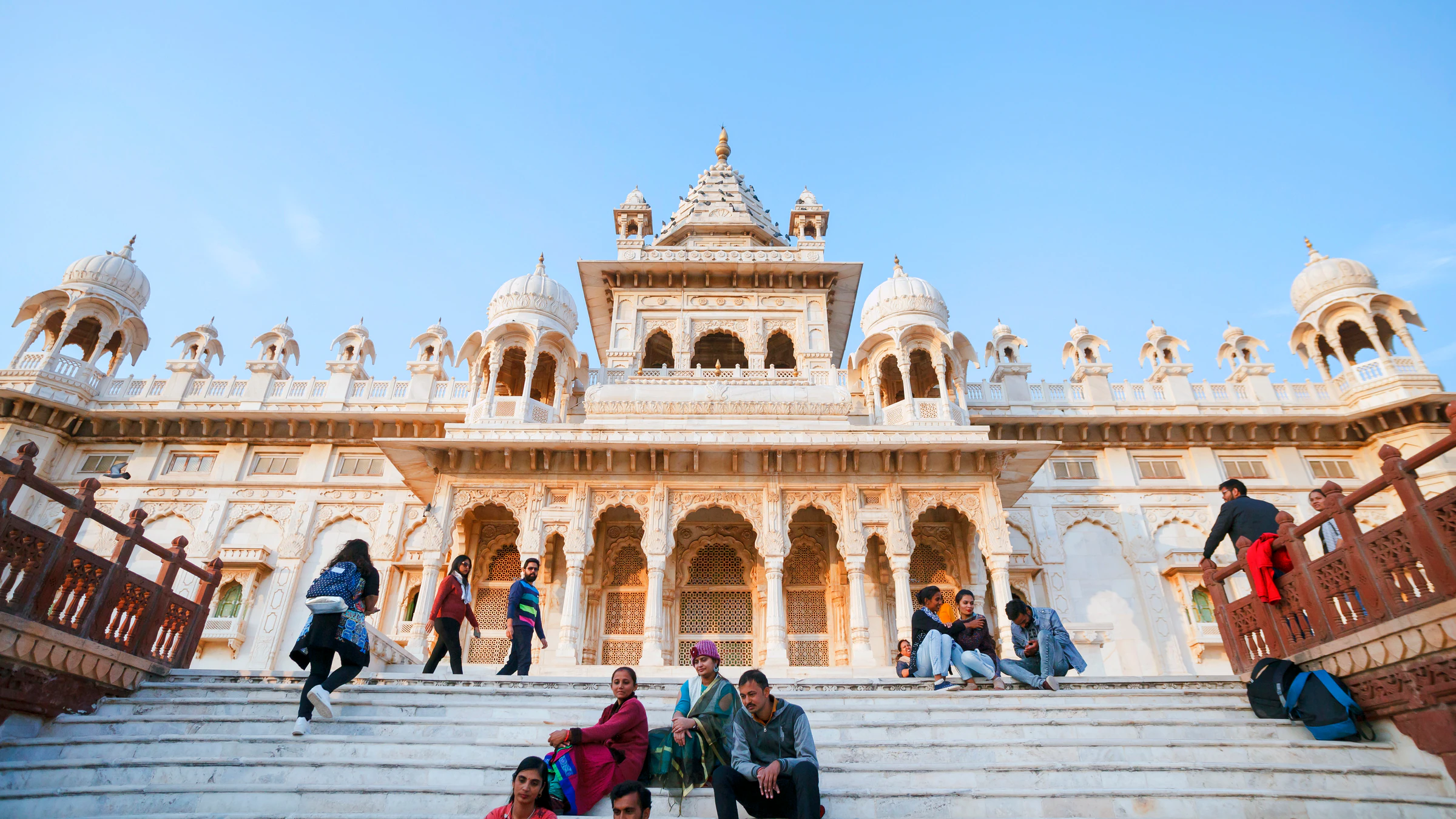 Visitors on the steps of Jaswant Thada, a white marble cenotaph in Jodhpur