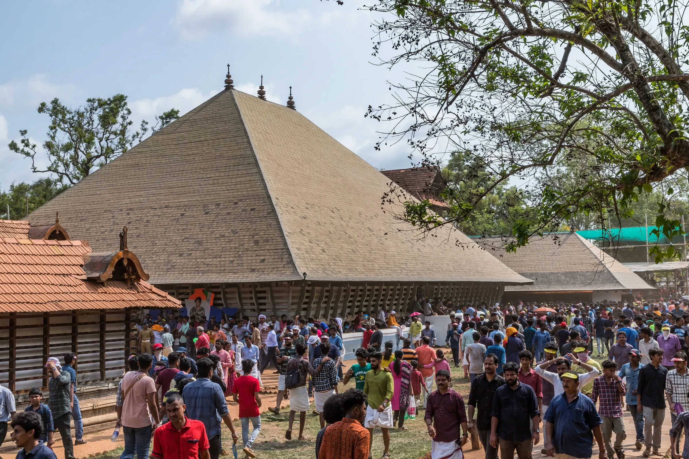 Crowds beside the large tiled hall at Vadakkunnathan Temple in Thrissur