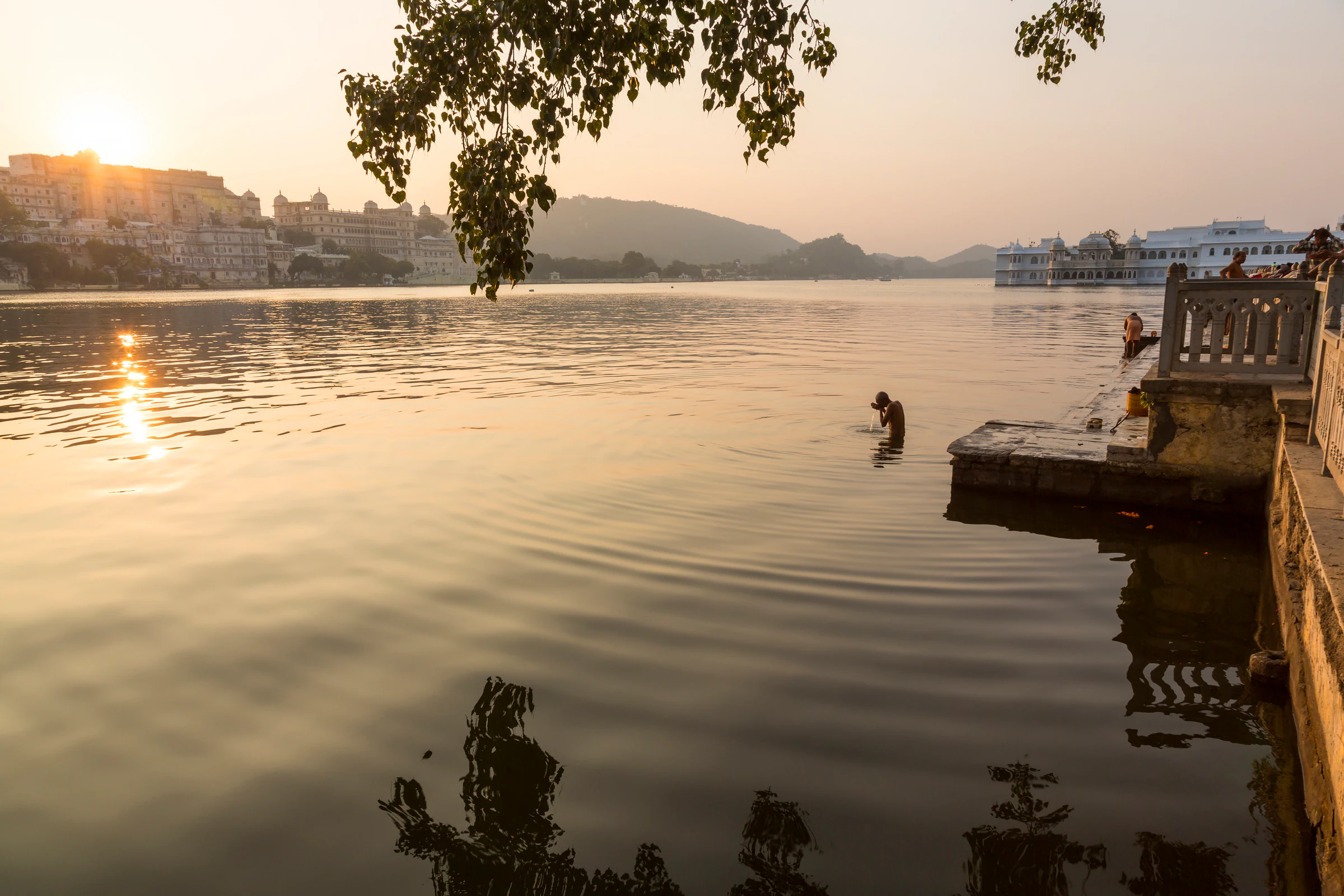 Low sun over Lake Pichola with the City Palace on the shore