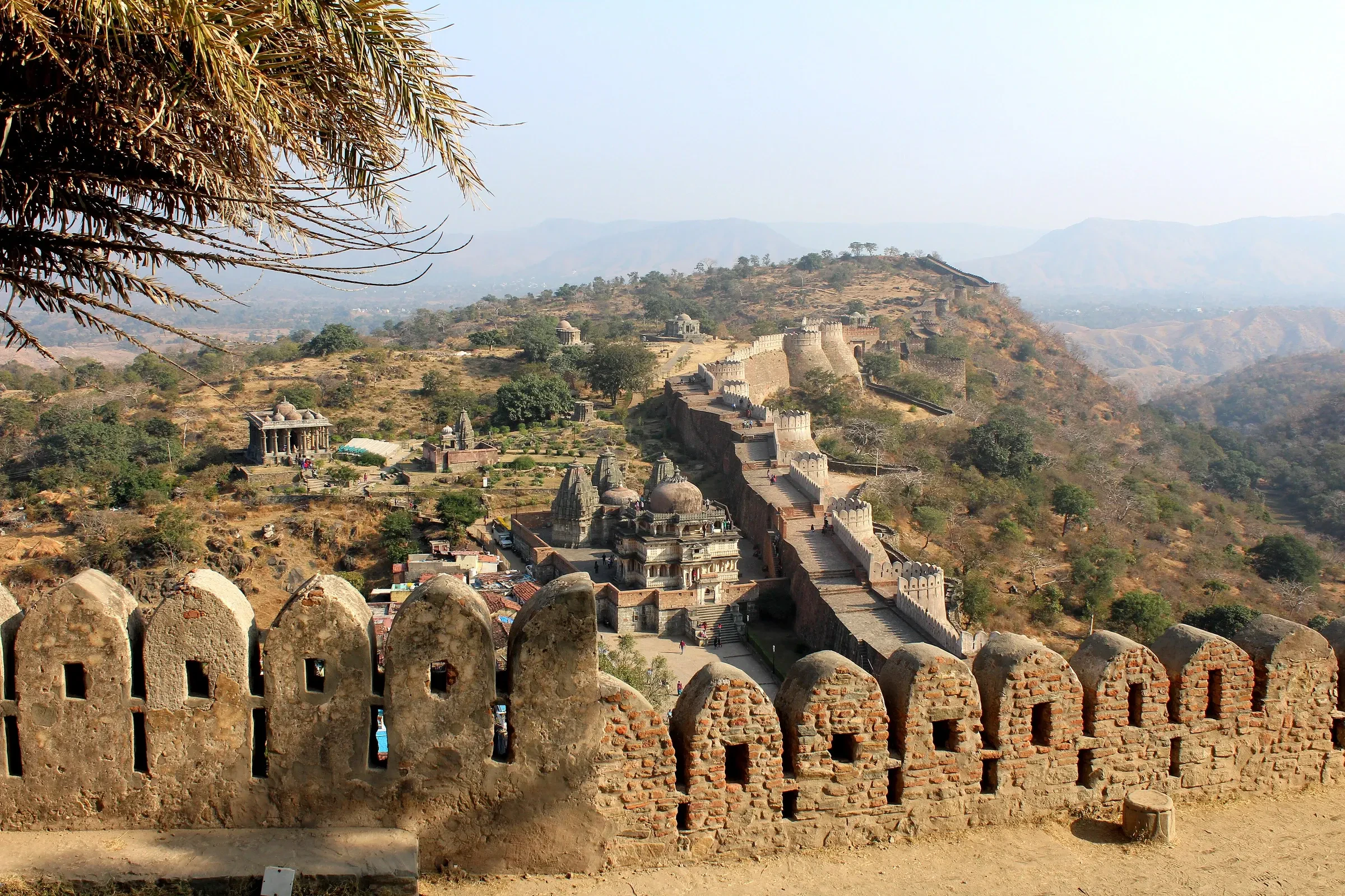 A crenellated wall and temples inside Kumbhalgarh Fort in Rajasthan