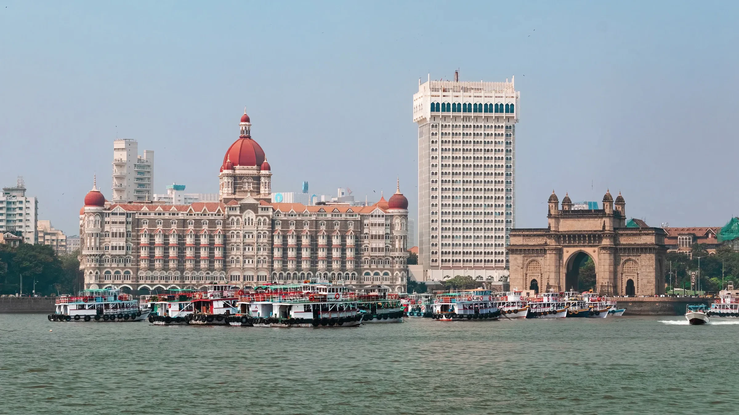 The Taj Mahal Palace hotel and the Gateway of India seen across the water in Mumbai