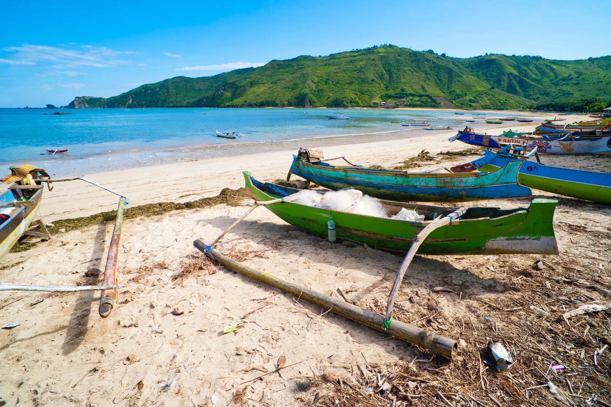 Traditional wooden fishing boats on a beach on Lombok's south coast near Kuta