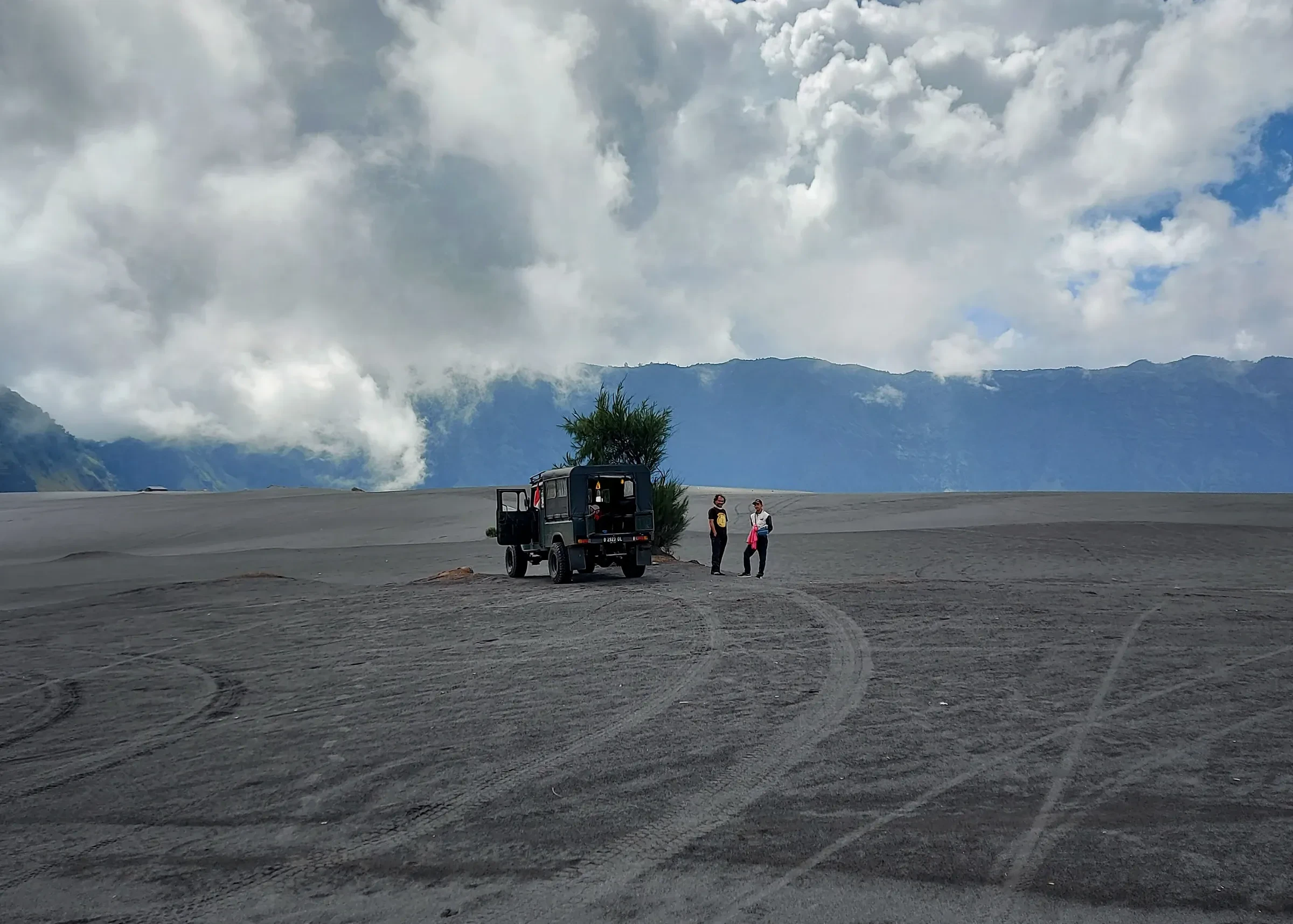 A 4WD jeep on the volcanic sand of Bromo's caldera floor