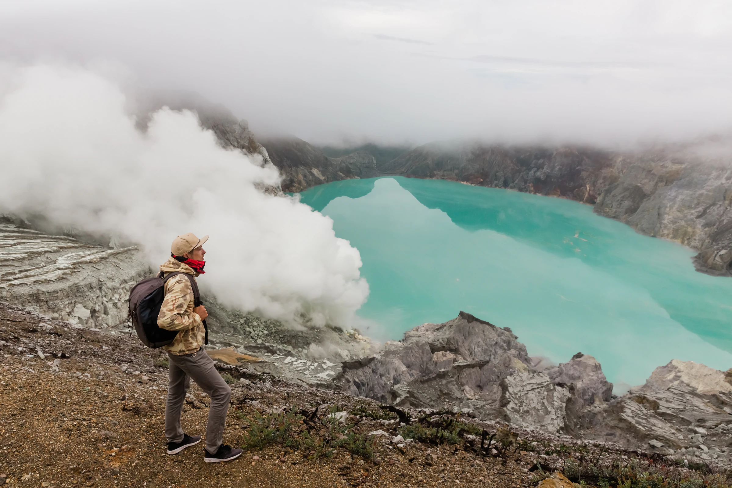 Ijen's turquoise, highly acidic crater lake seen from the rim at daylight