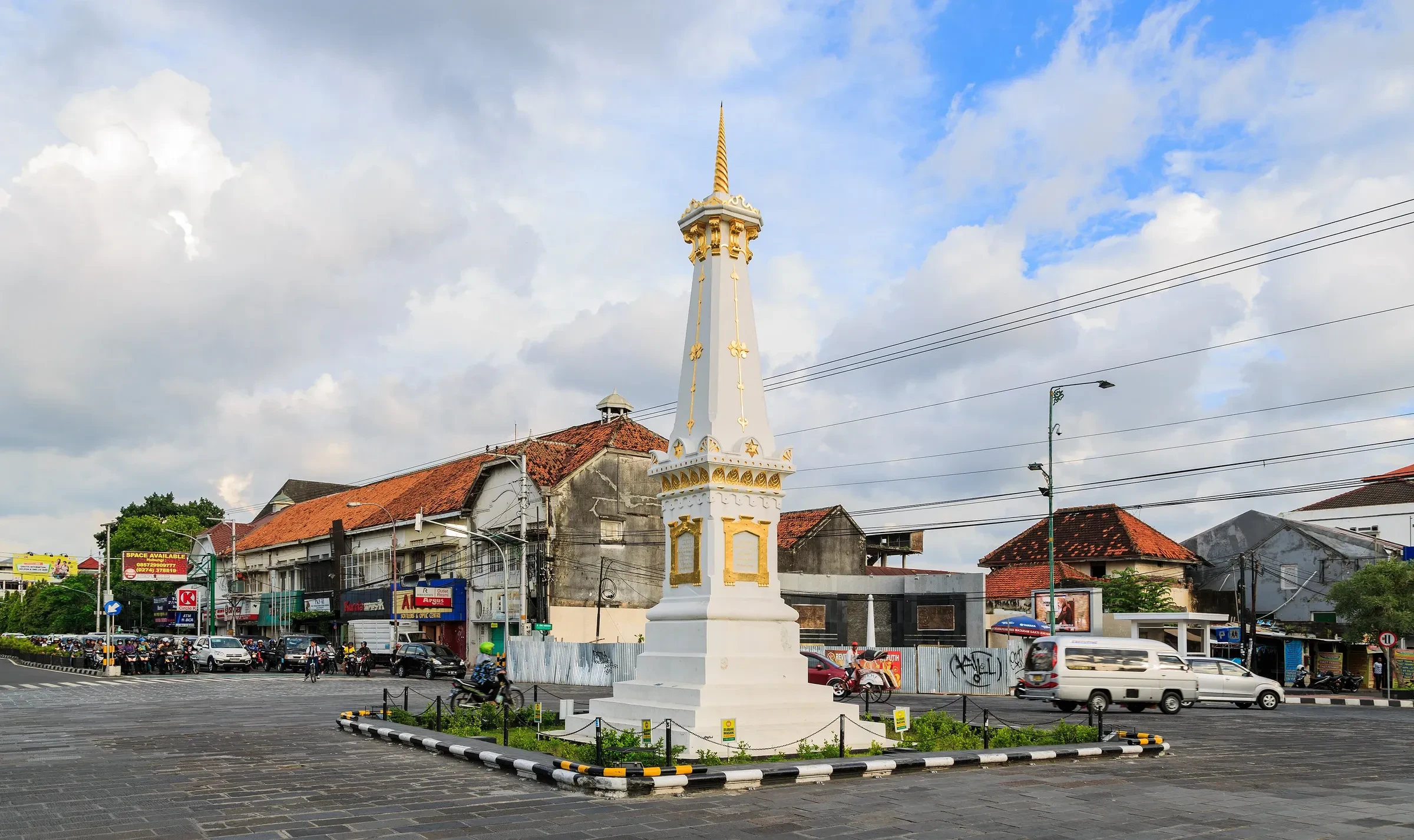 The white Tugu monument at a busy crossroads in Yogyakarta