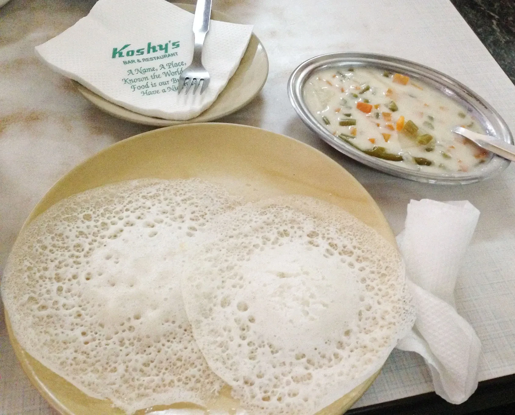 Appam with vegetable stew, a classic Kerala breakfast