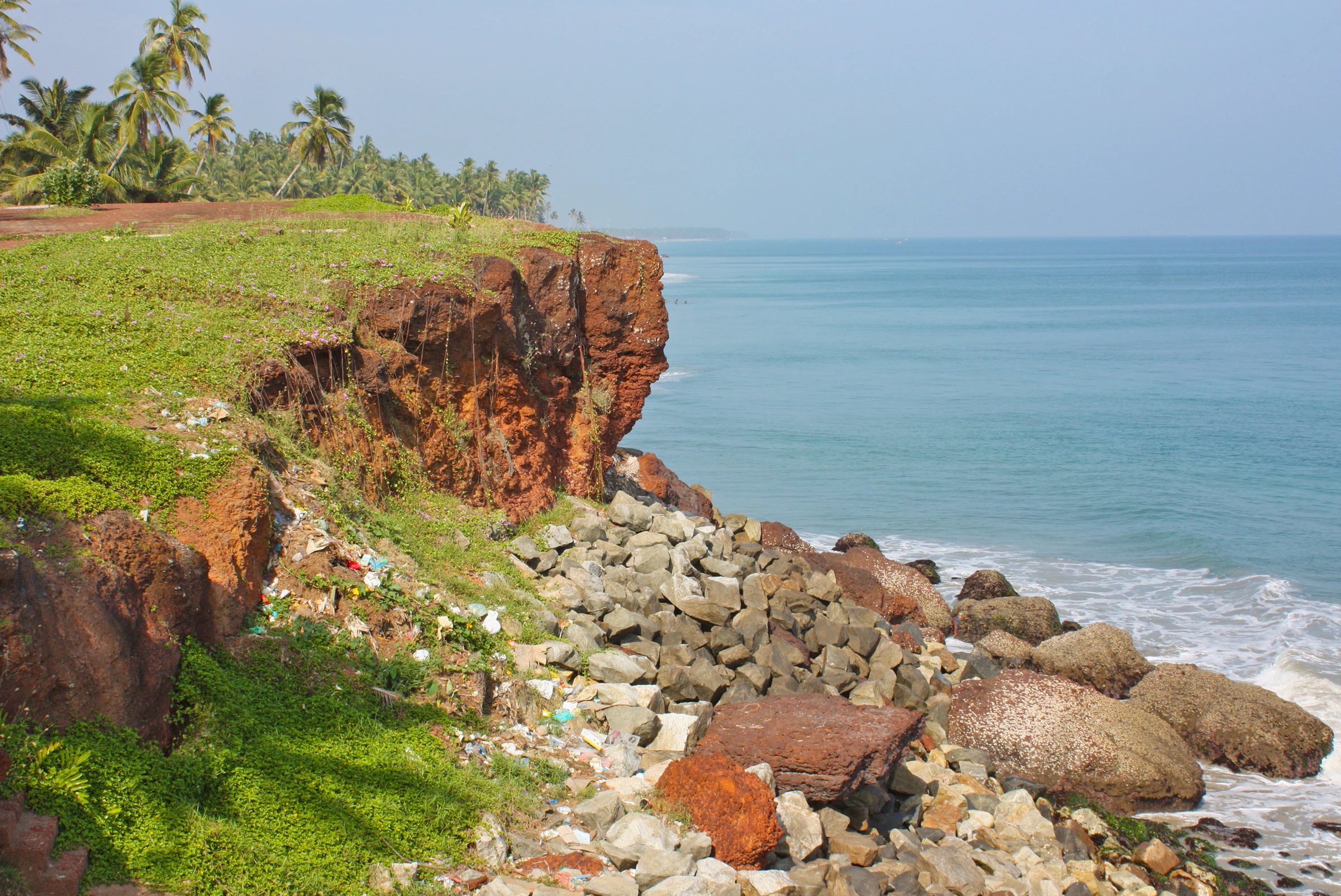 A red cliff and rocky shore on the Varkala coast