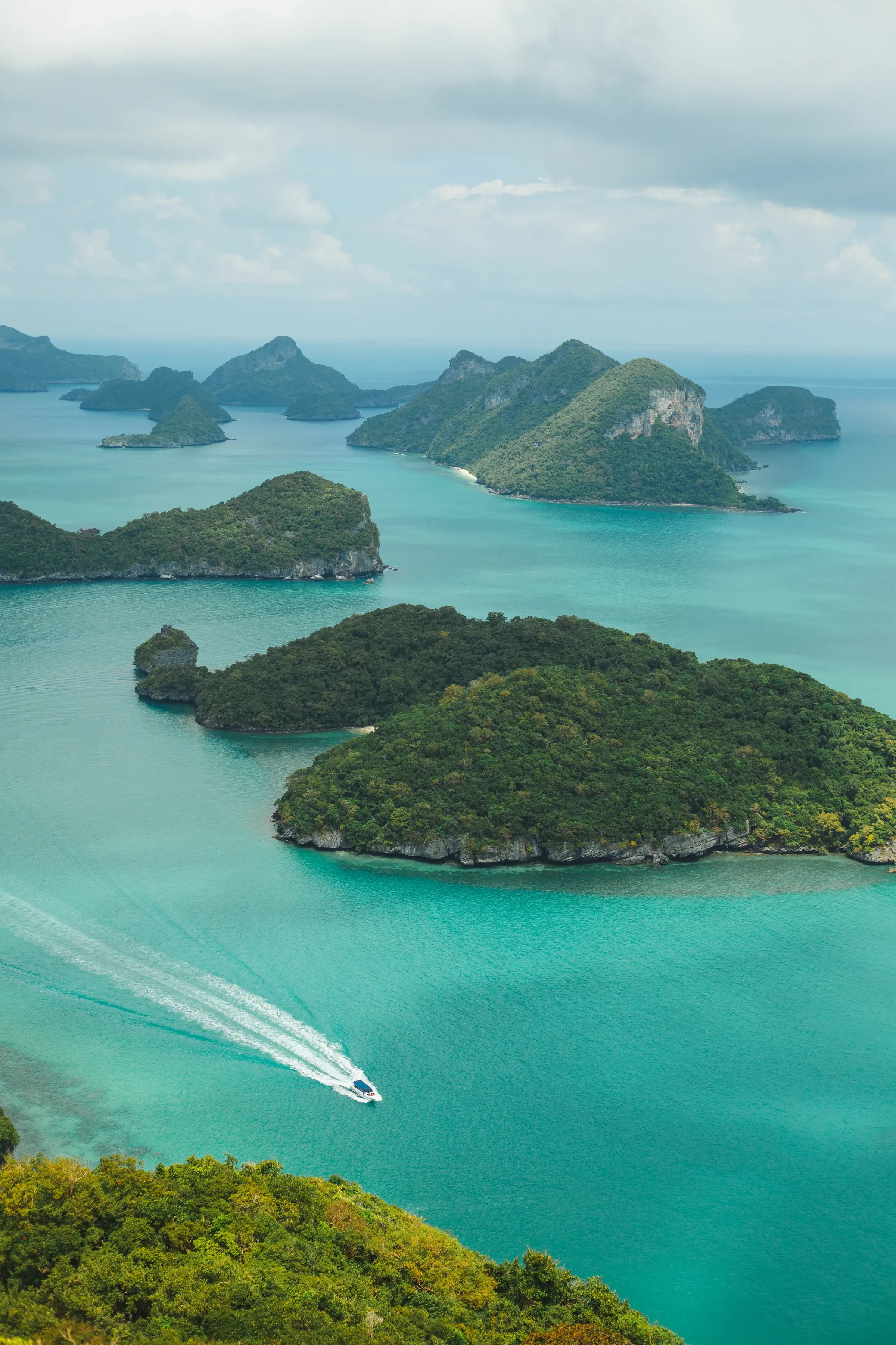 Kayakers paddling beneath a limestone island in Ang Thong Marine Park
