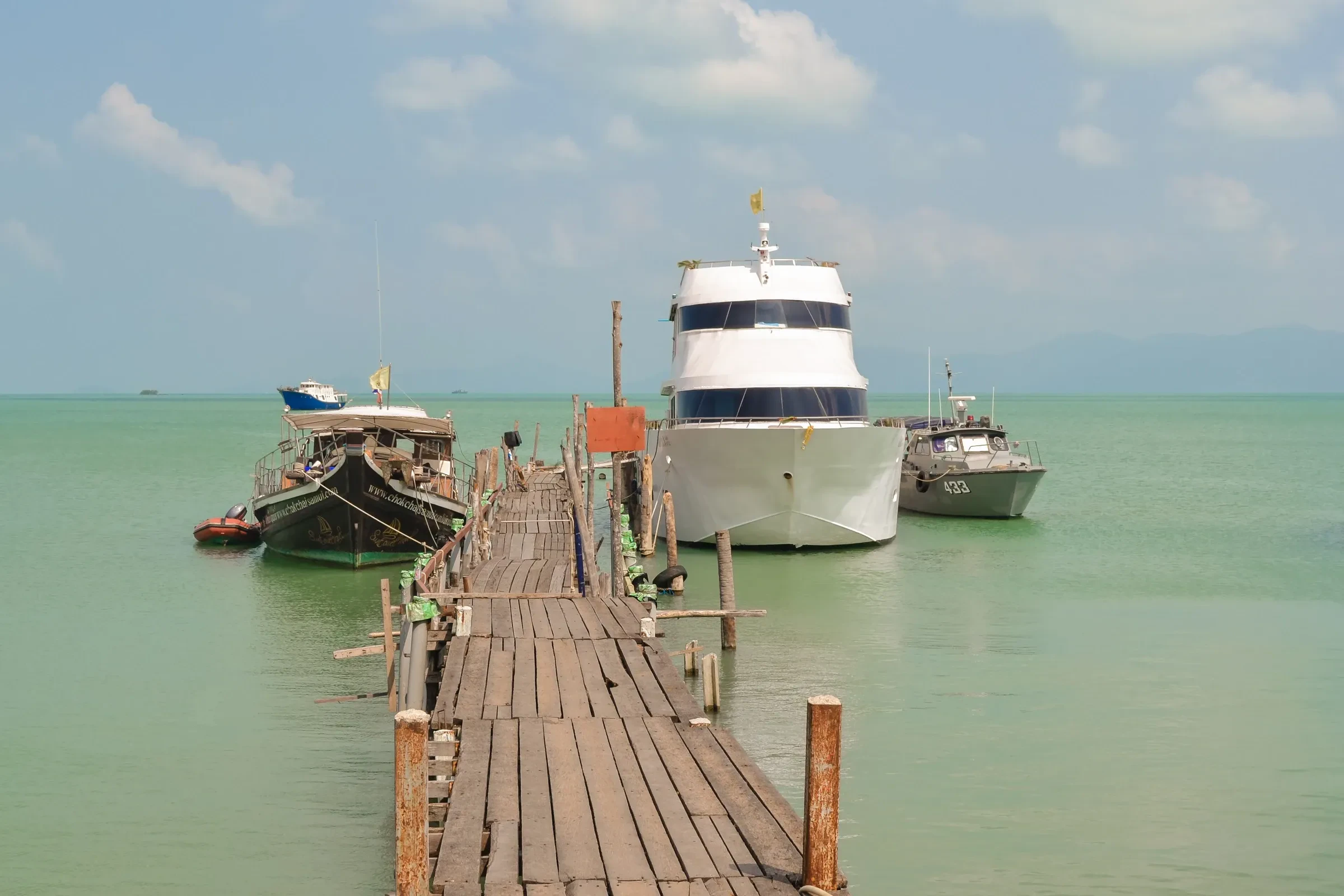 A wooden pier and moored boats at Bophut village on Koh Samui