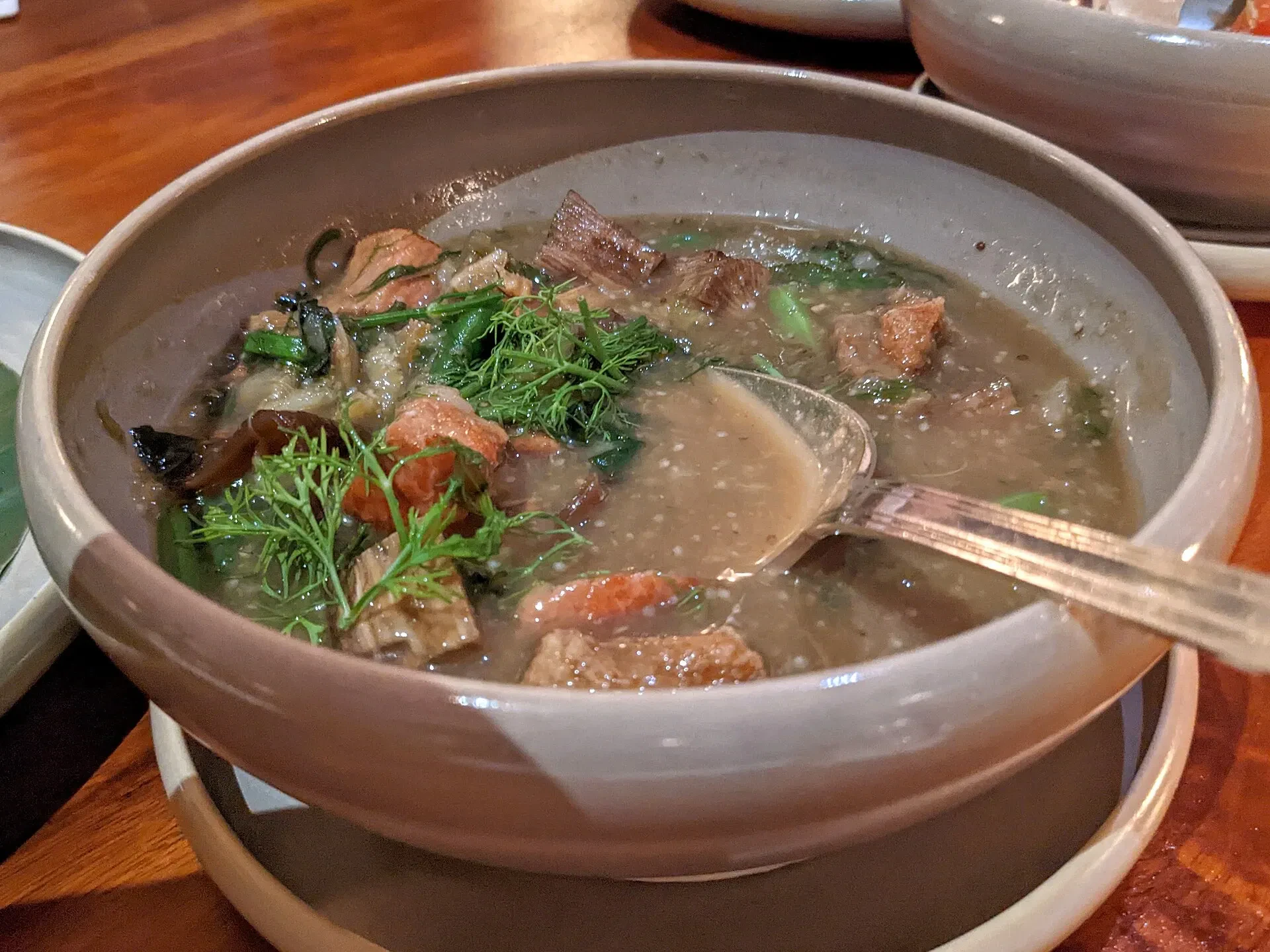 A bowl of or lam, the Luang Prabang stew, served in a stoneware bowl