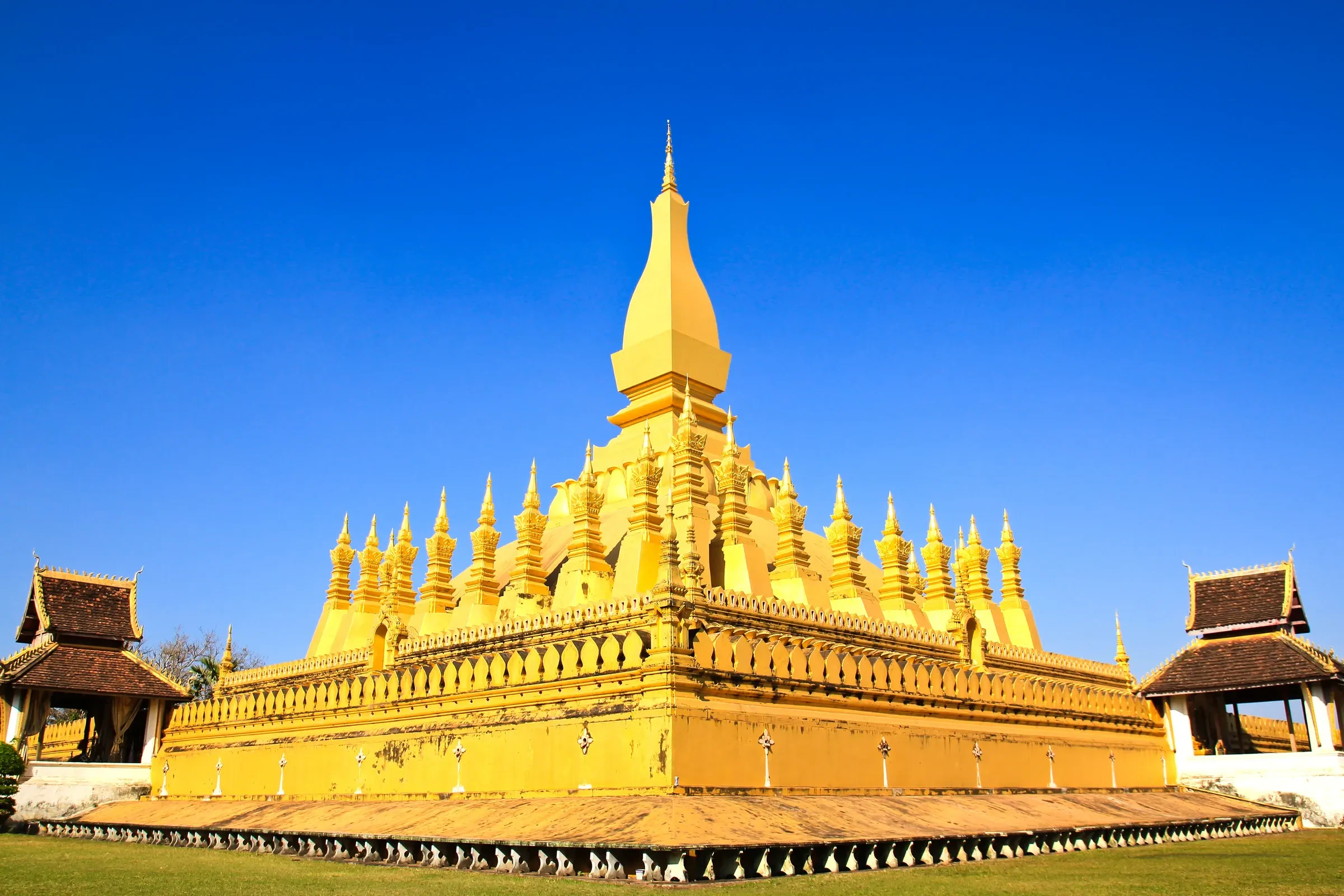 The golden stupa of Pha That Luang in Vientiane under a blue sky