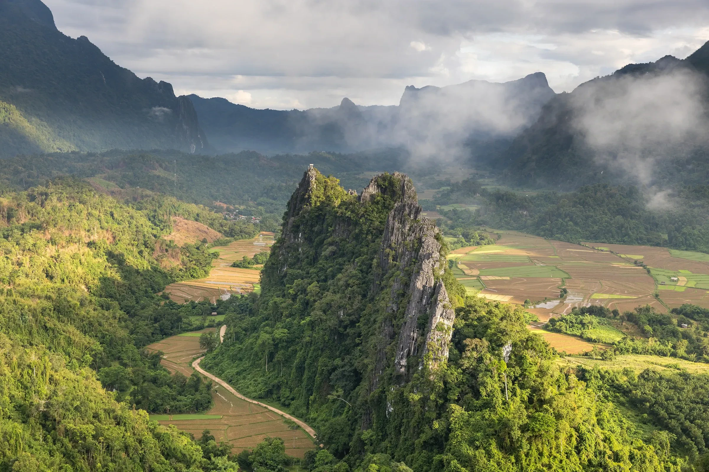 A limestone peak and green valley seen from the Nam Xay viewpoint near Vang Vieng