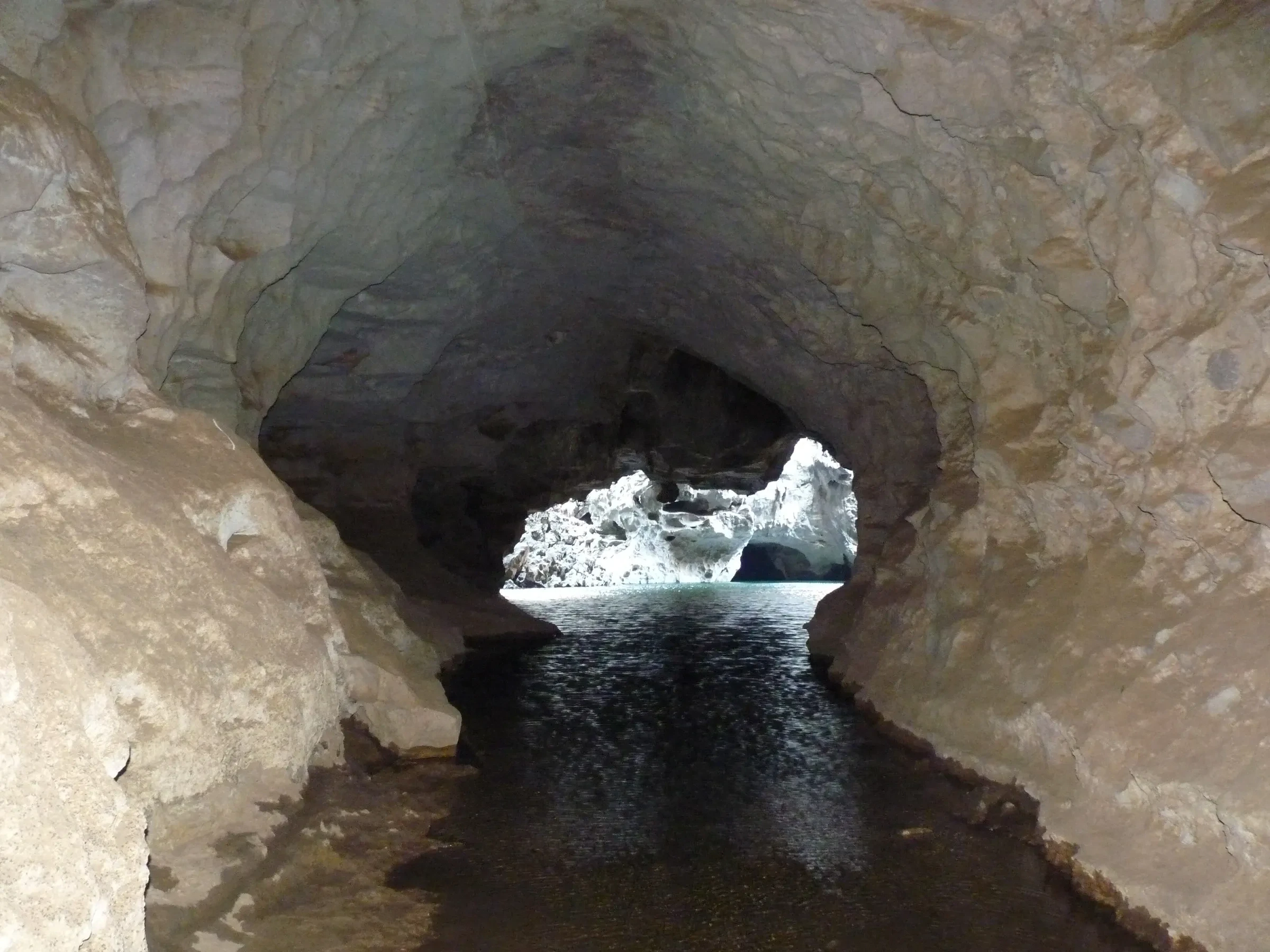 A river flowing through the narrow tunnel of Phan Ya In cave in Khammouane