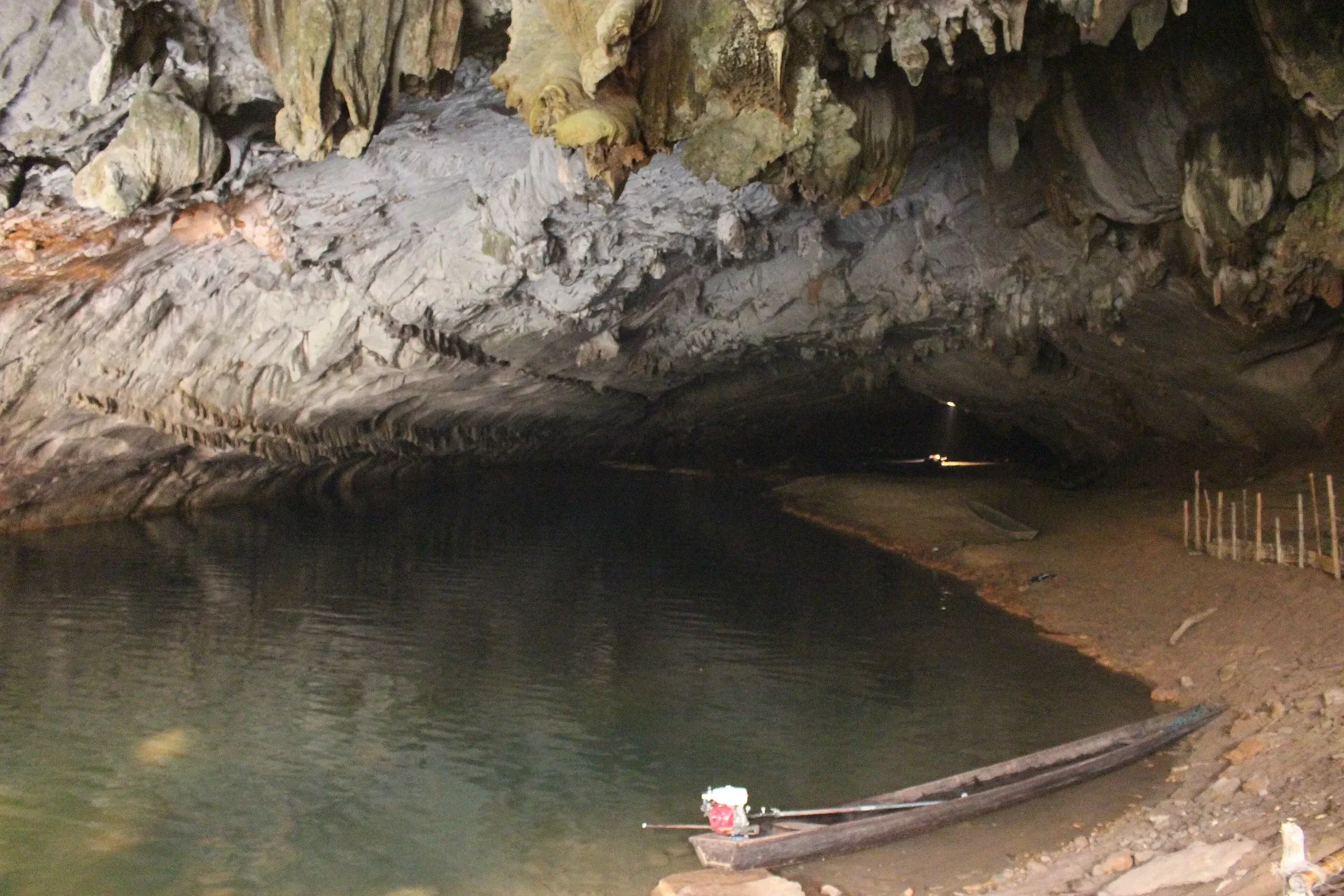 A wooden boat moored inside the Kong Lor cave in Laos