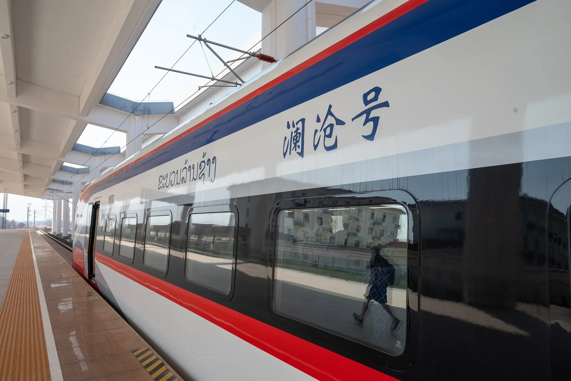 A Laos-China Railway train at a station platform in Laos