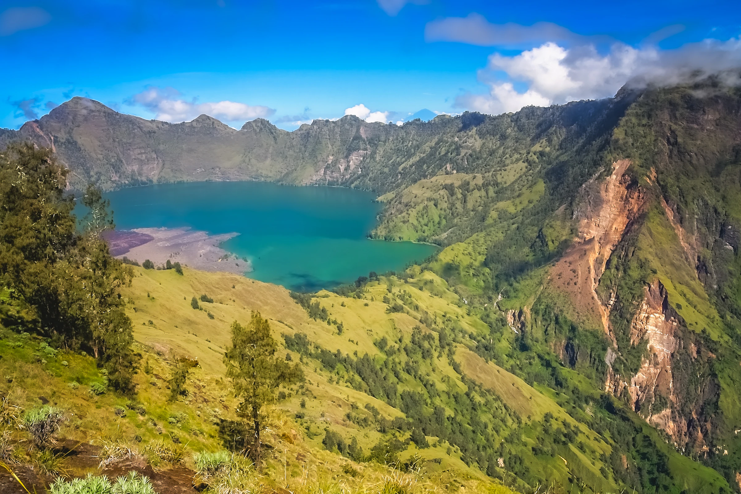 The turquoise Segara Anak crater lake inside Mount Rinjani's caldera