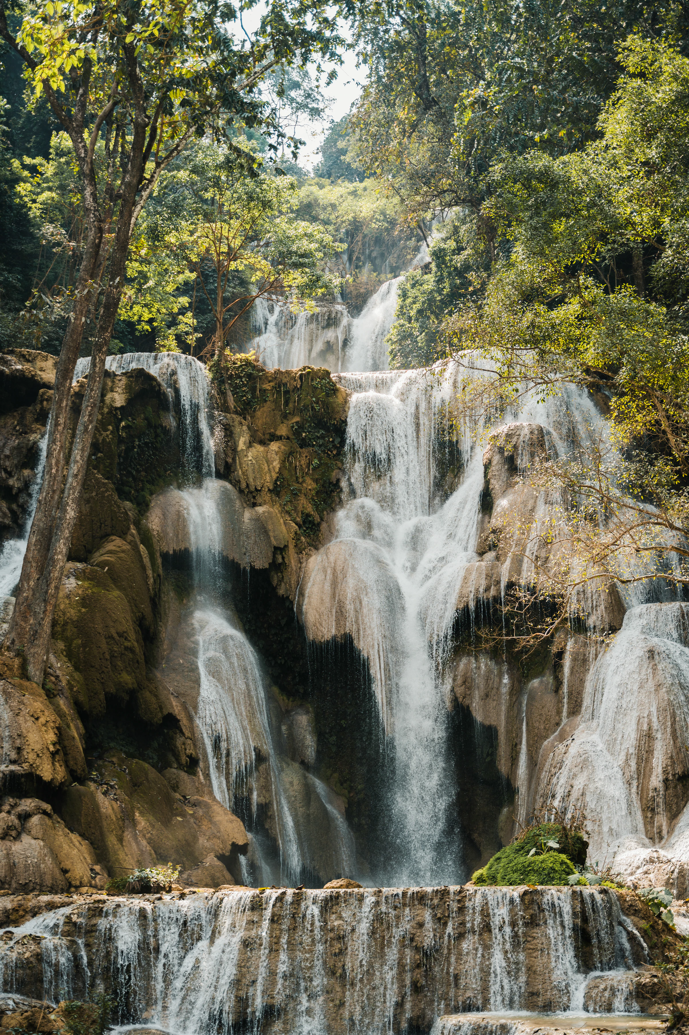 The turquoise tiers of Kuang Si Falls in the forest near Luang Prabang