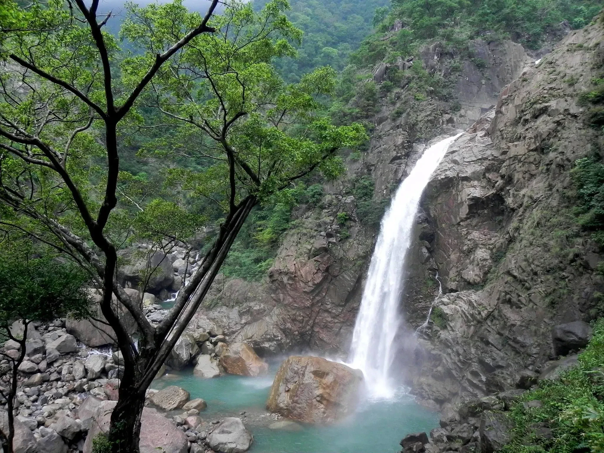 Rainbow Falls dropping into a turquoise pool near Nongriat, Meghalaya