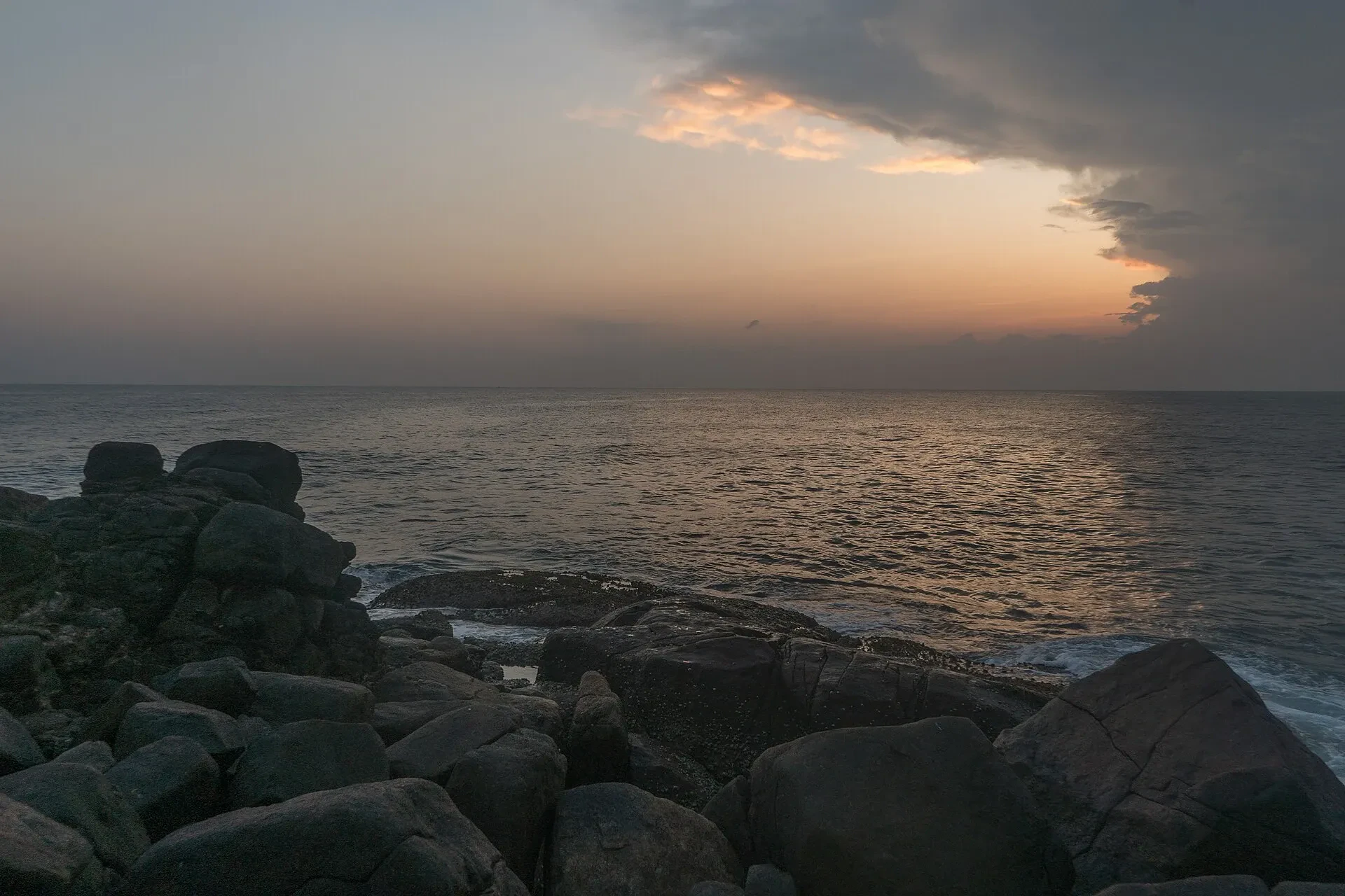 The sun setting over the Indian Ocean, seen from the rocks of Parrot Rock in Mirissa