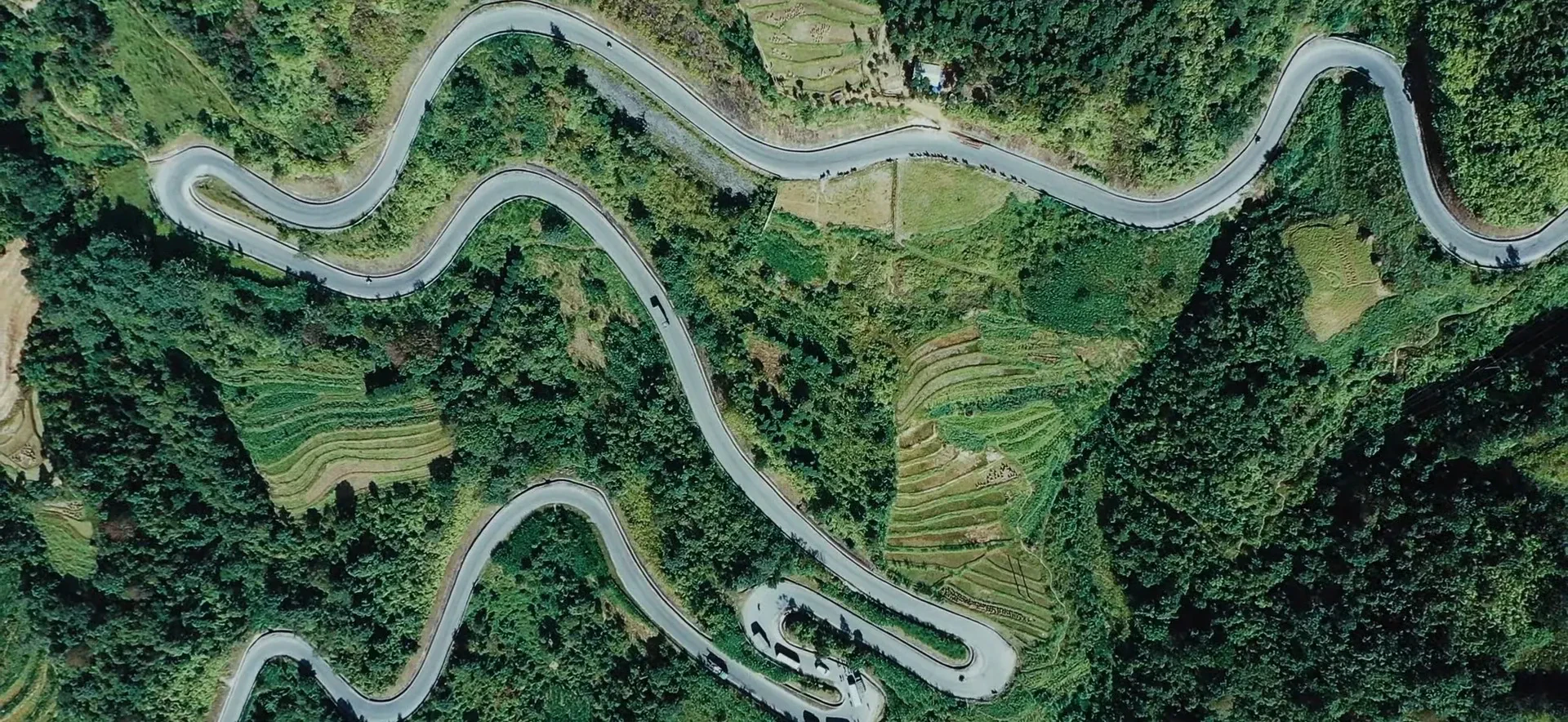 A mountain road with hairpin bends seen from above near Ma Pi Leng Pass