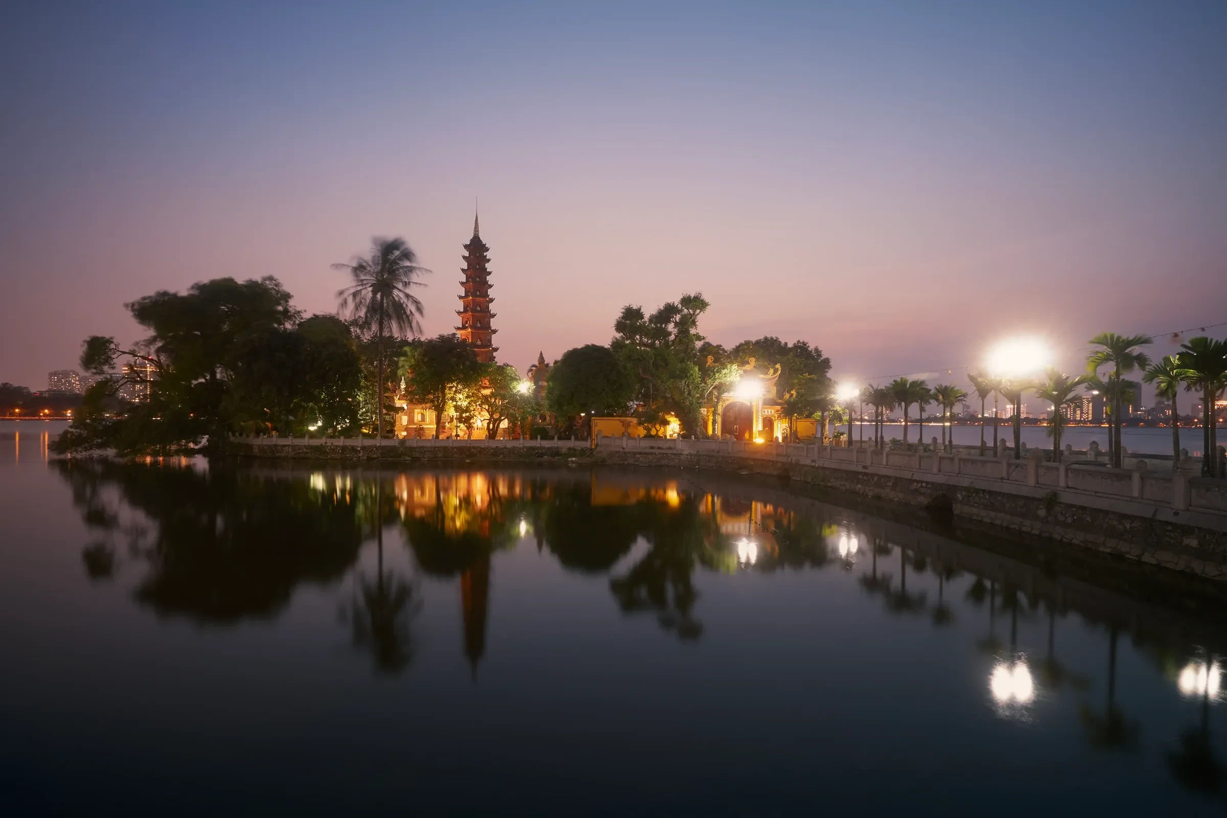 A pagoda reflected in a Hanoi lake at dusk