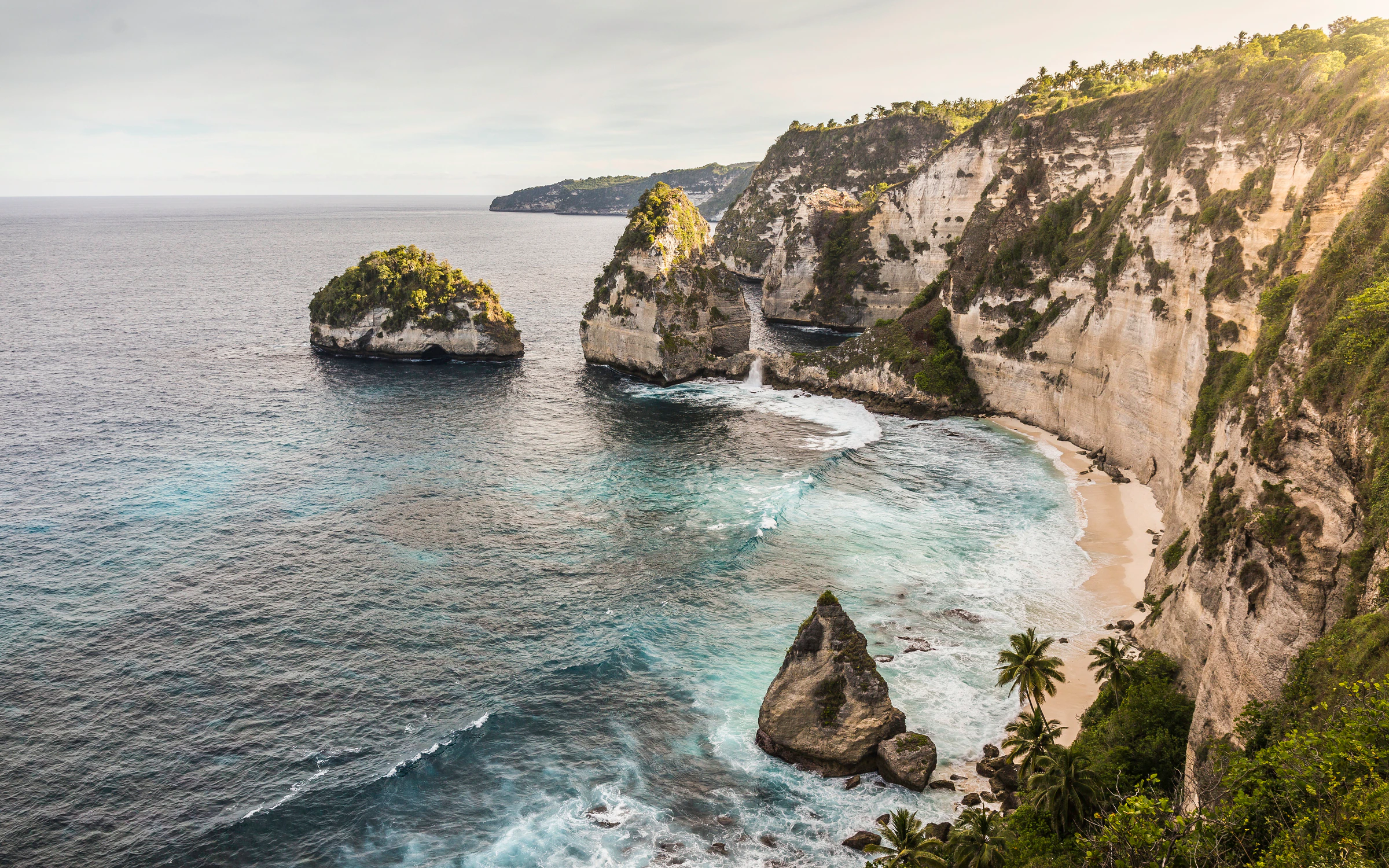 Rock stacks off the white sand of Diamond Beach, below the cliffs on Nusa Penida's east coast