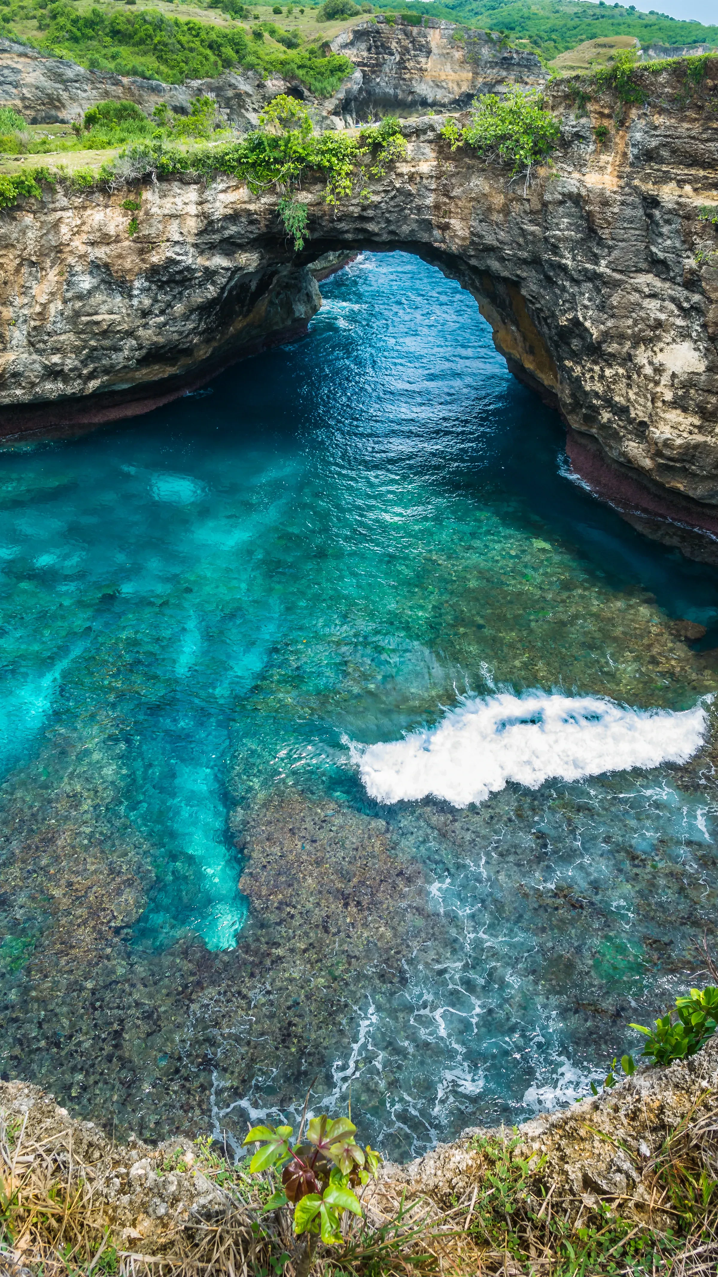 The sea arch over a turquoise lagoon at Broken Beach on Nusa Penida