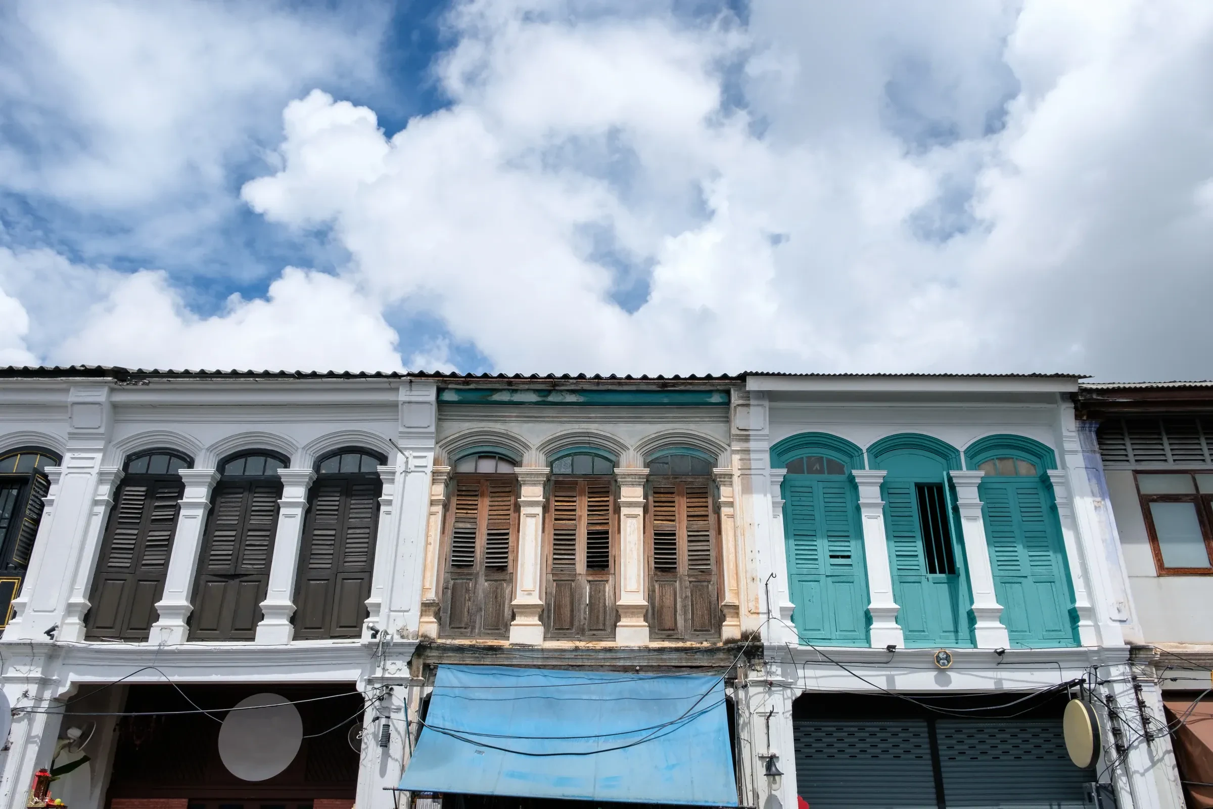 A Sino-Portuguese shophouse facade in Phuket Old Town, painted in pastel colours