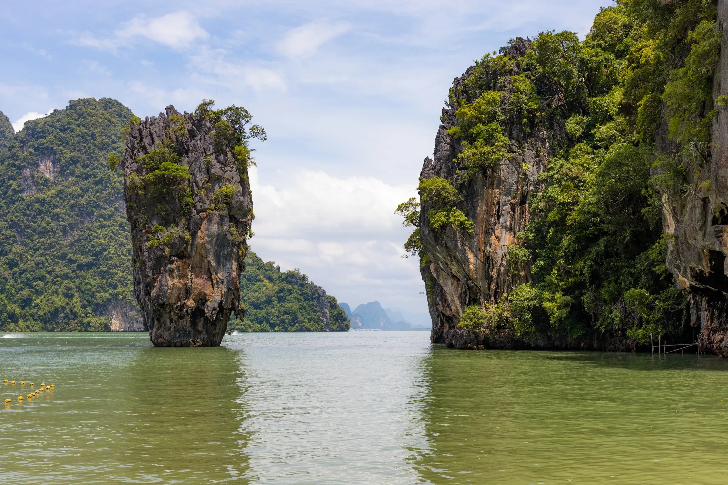 Limestone karst towers rising from calm water in Phang Nga Bay