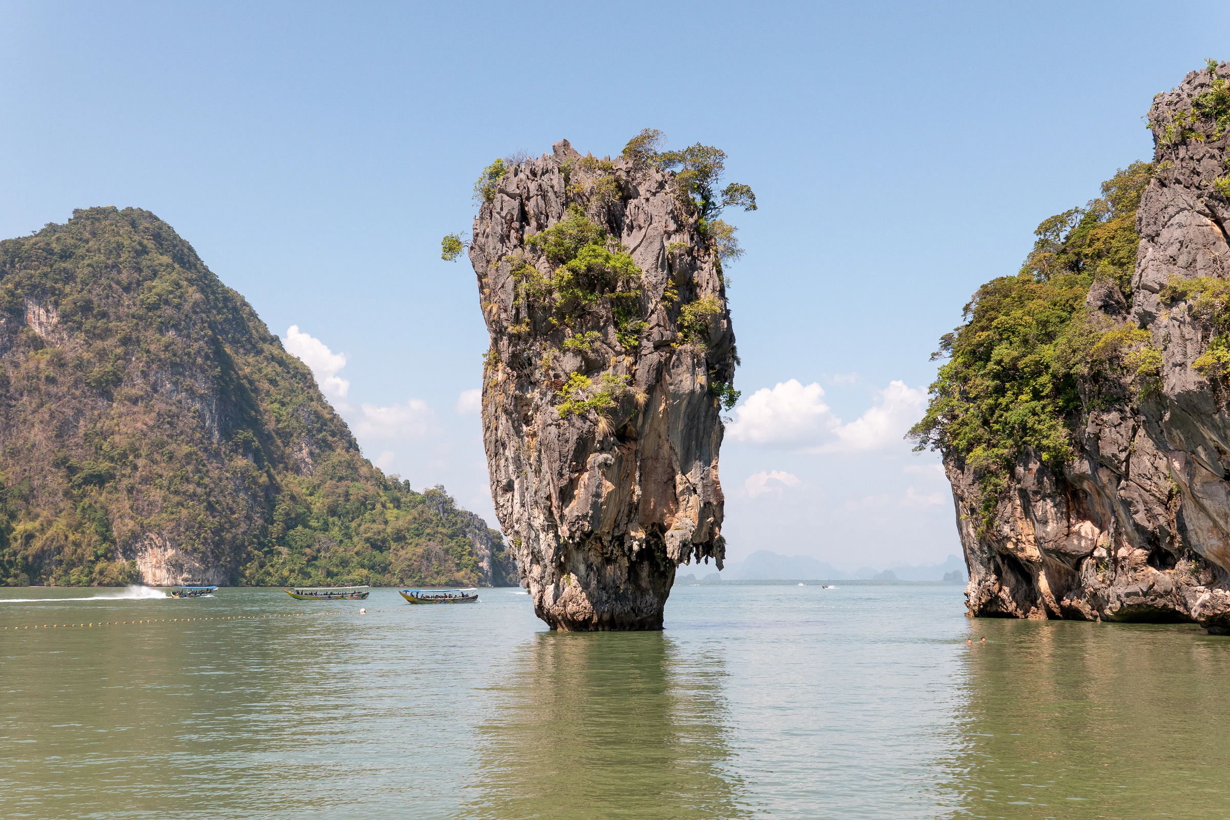 Limestone karst towers rising from the water in Phang Nga Bay