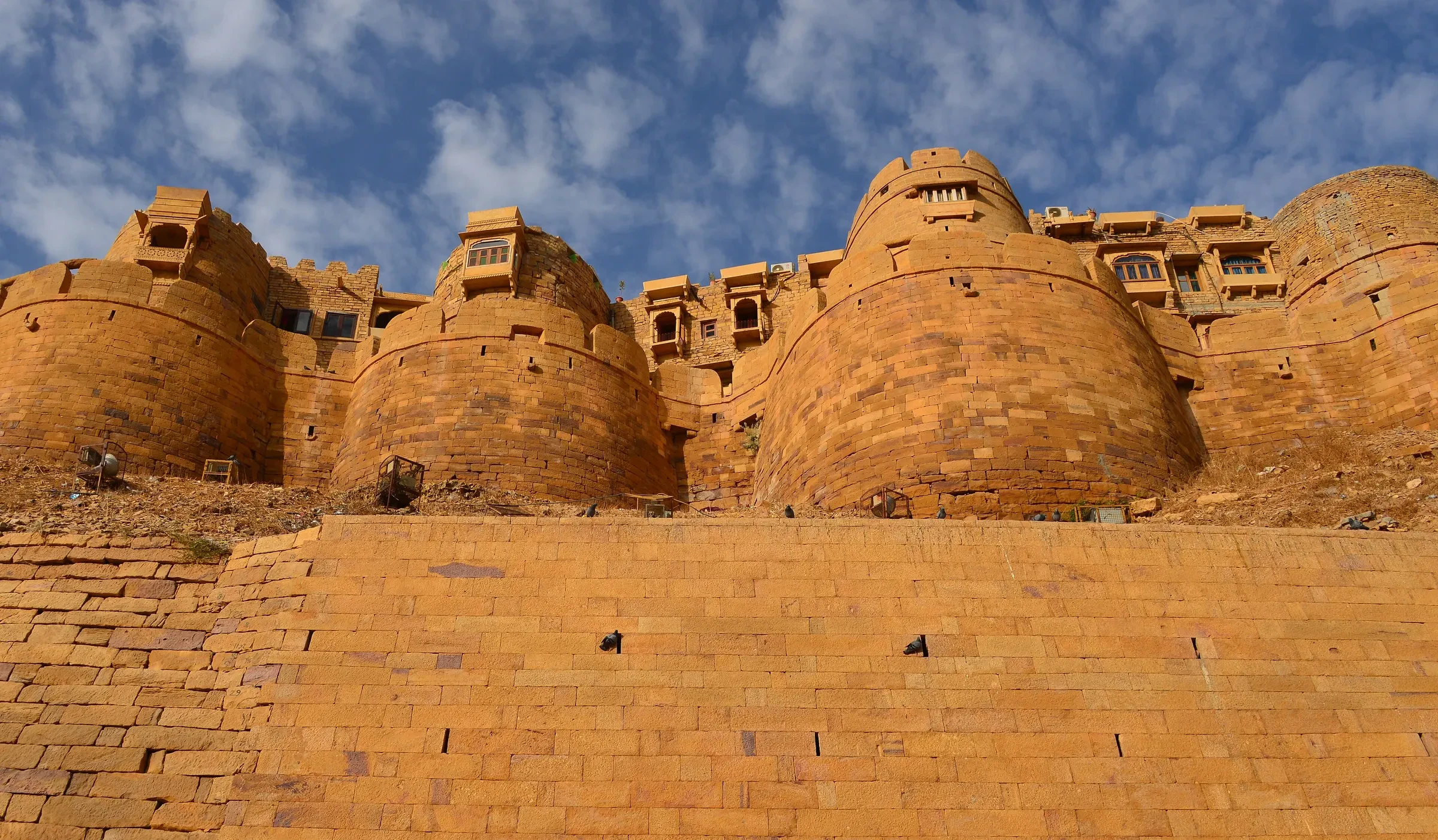The sandstone ramparts of Jaisalmer Fort against a blue sky