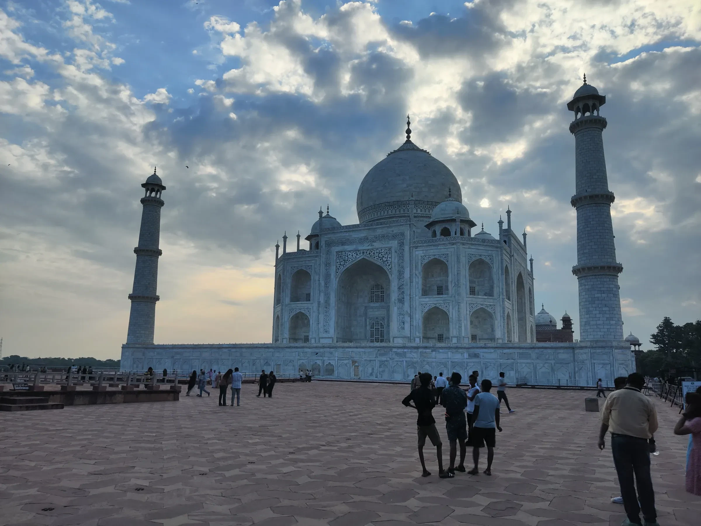 The Taj Mahal in the morning light, with visitors on the platform in front