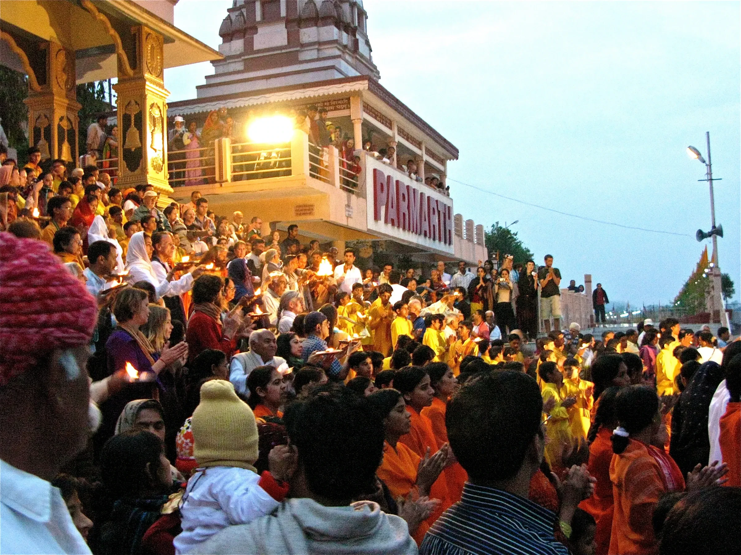 Crowds seated by the river for the evening Ganga Aarti in Rishikesh