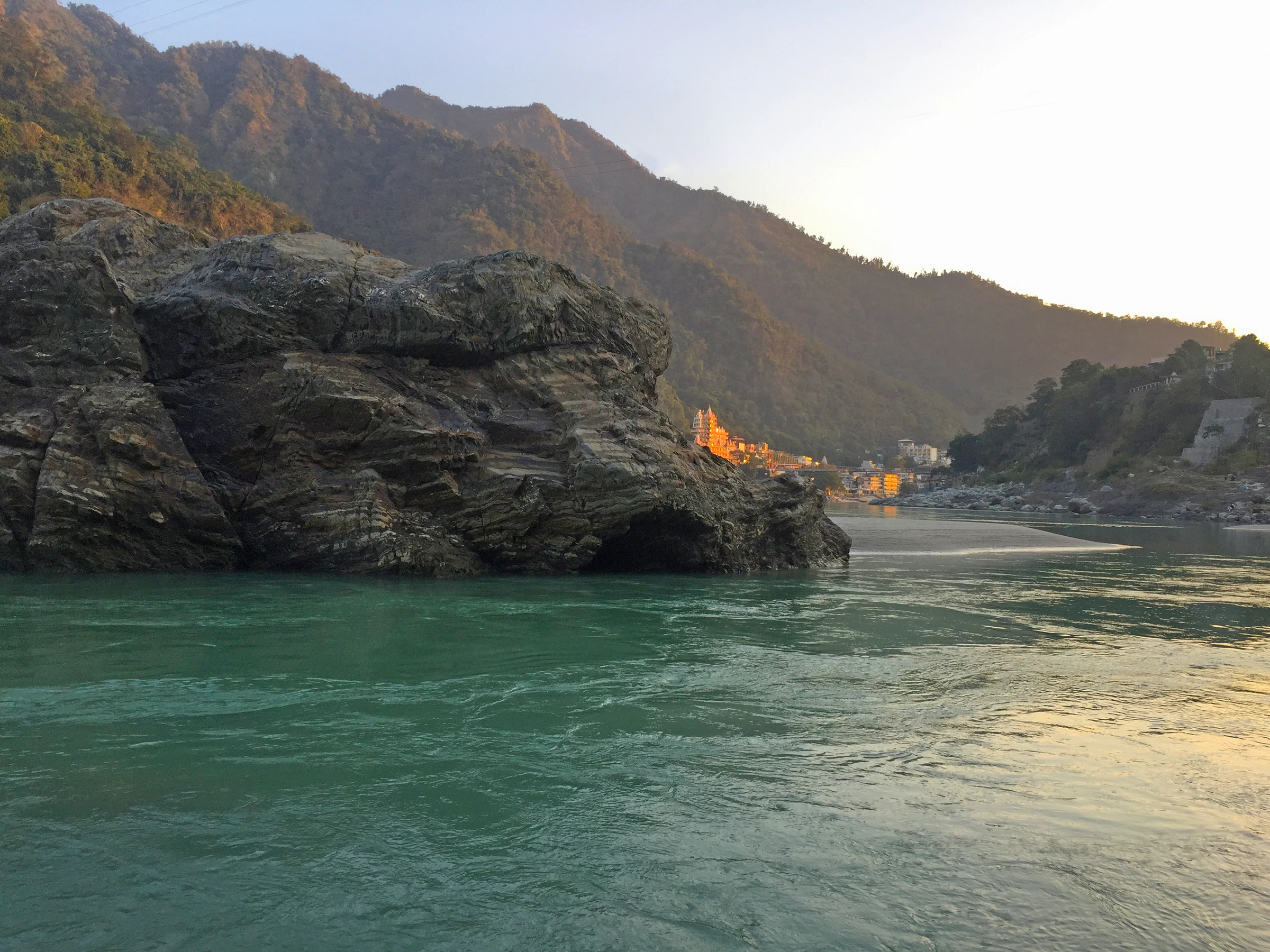 The Ganga running clear and green through the Rishikesh valley on a clear autumn day