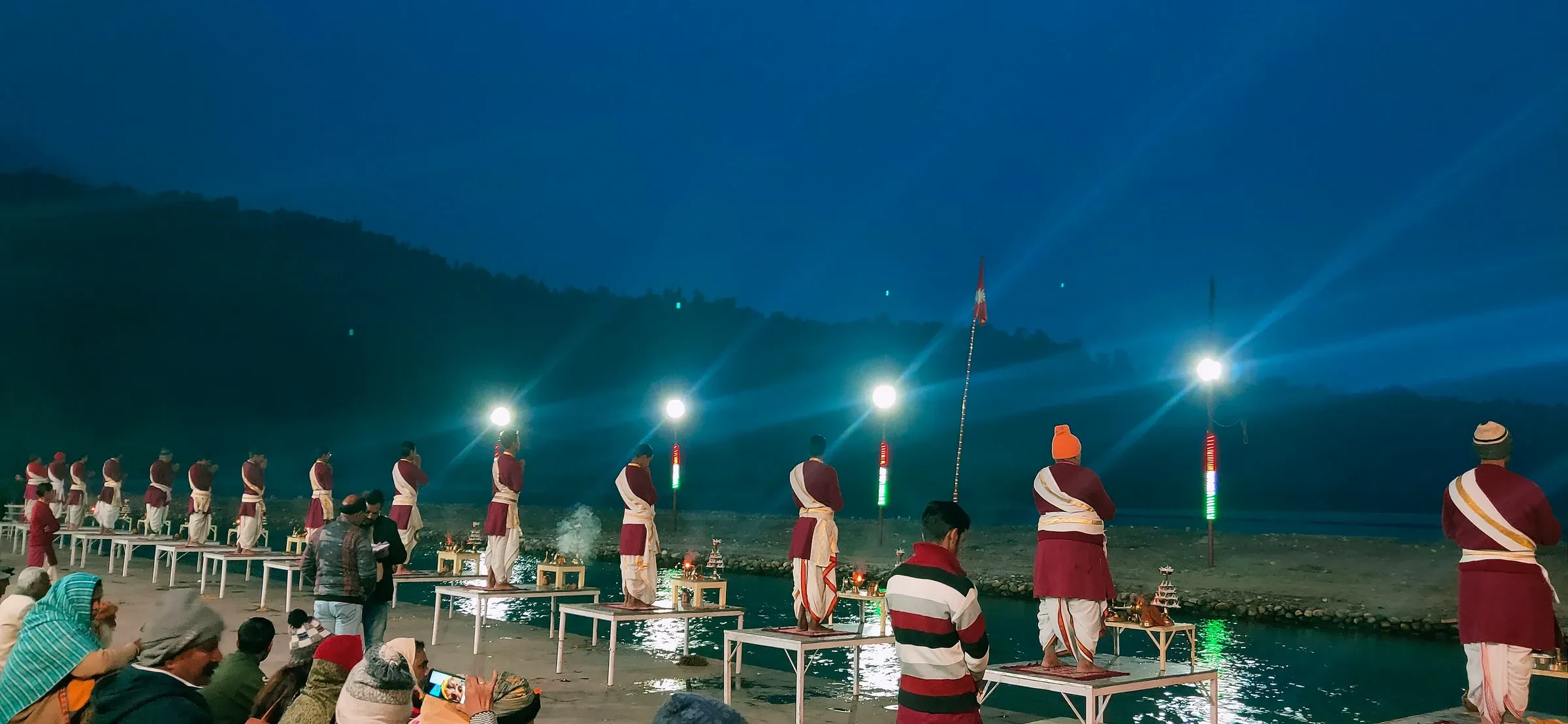 Priests lifting lamps at the evening Ganga Aarti at Triveni Ghat in Rishikesh