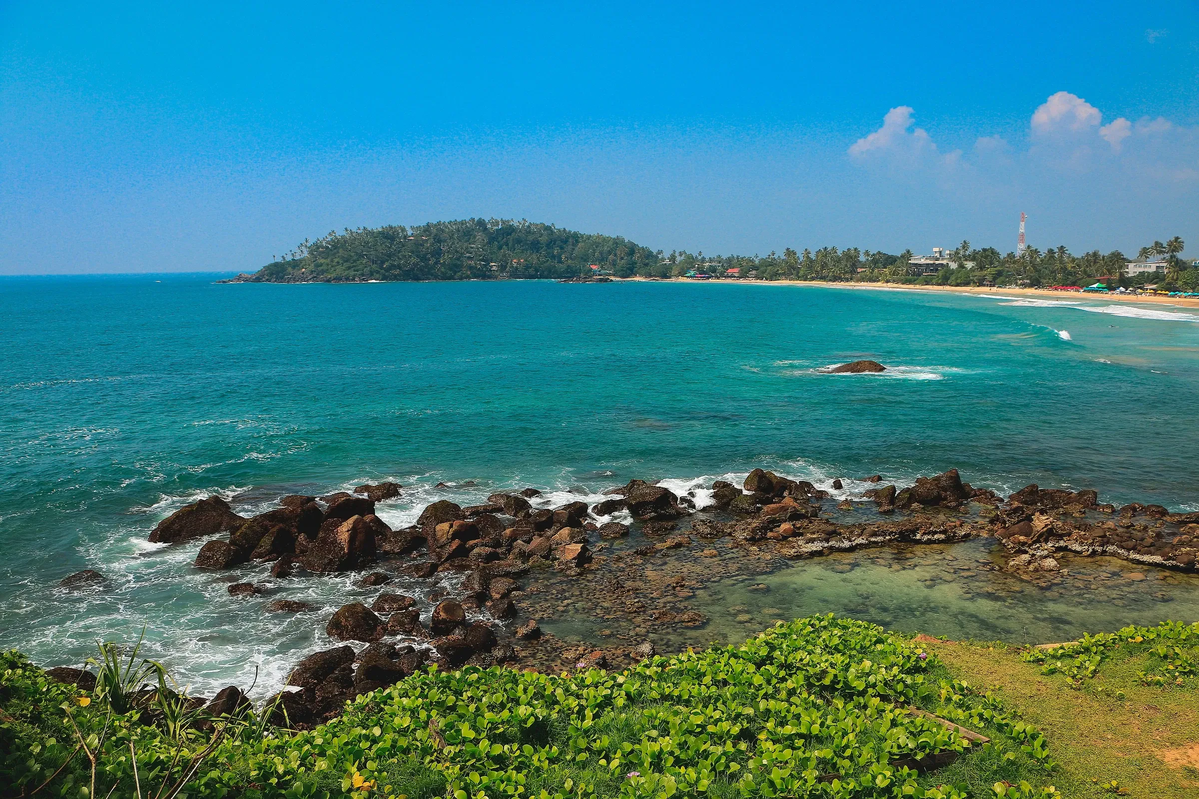 A rocky shore and sandy bay at Mirissa on the south coast of Sri Lanka