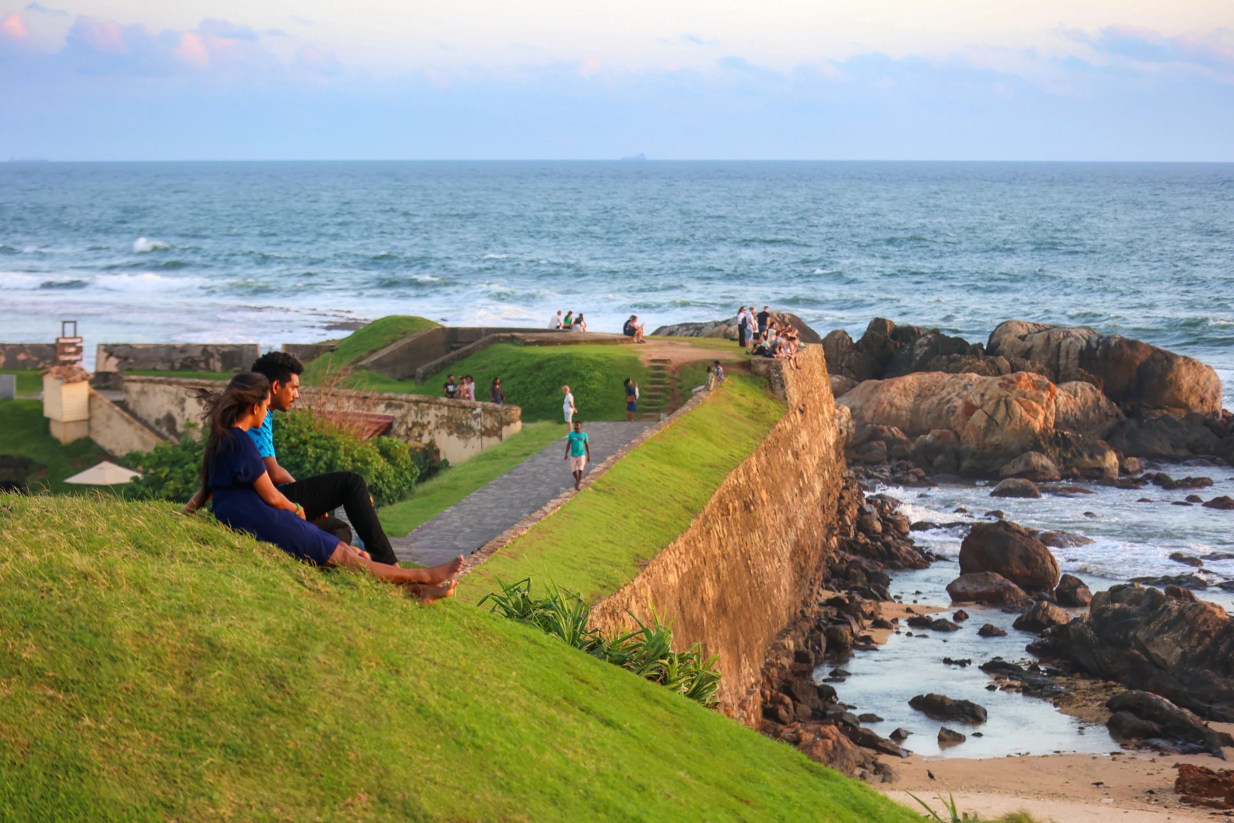 A couple watching the sunset from the ramparts of Galle Fort