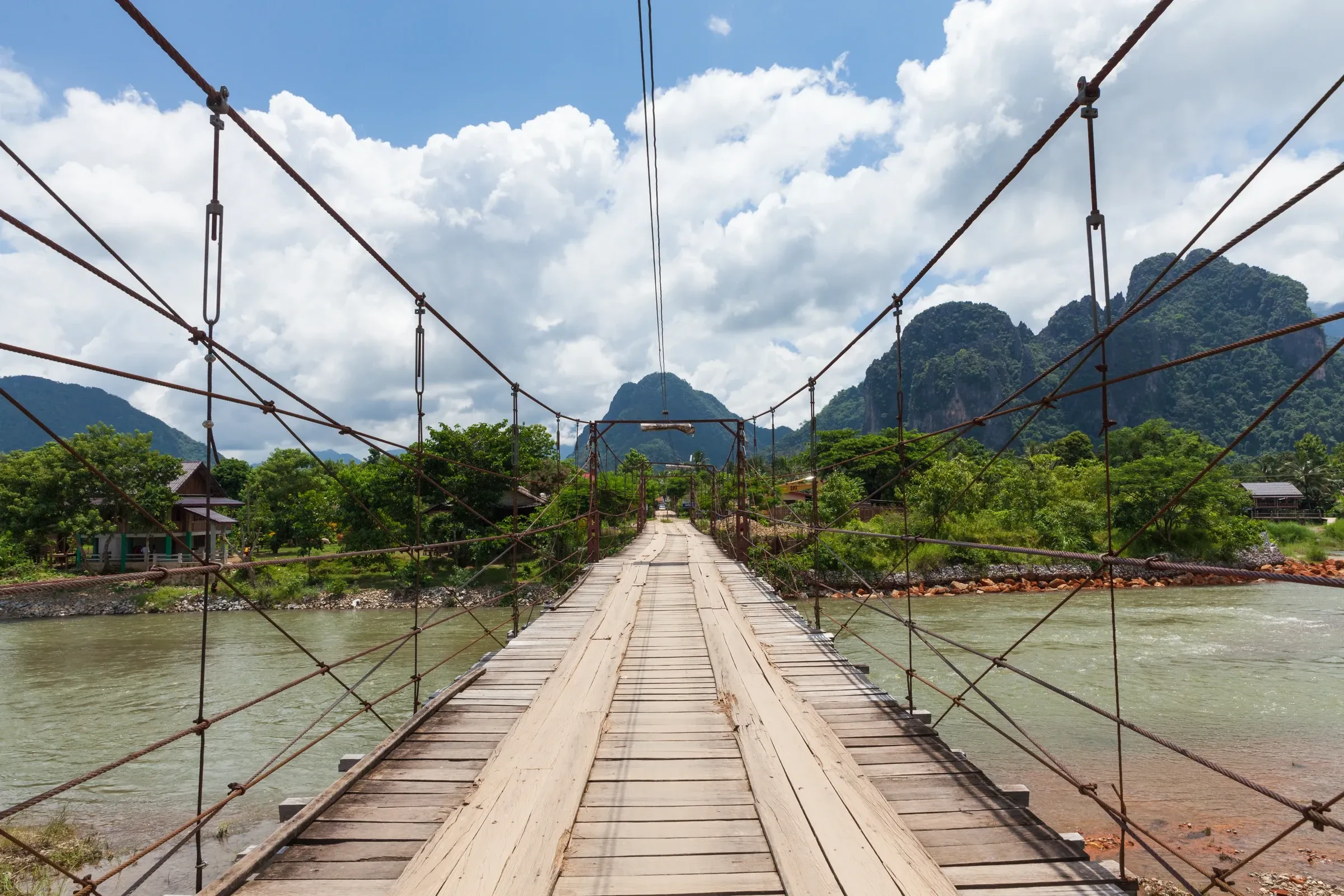 A wooden suspension bridge over the Nam Song river in Vang Vieng, Laos
