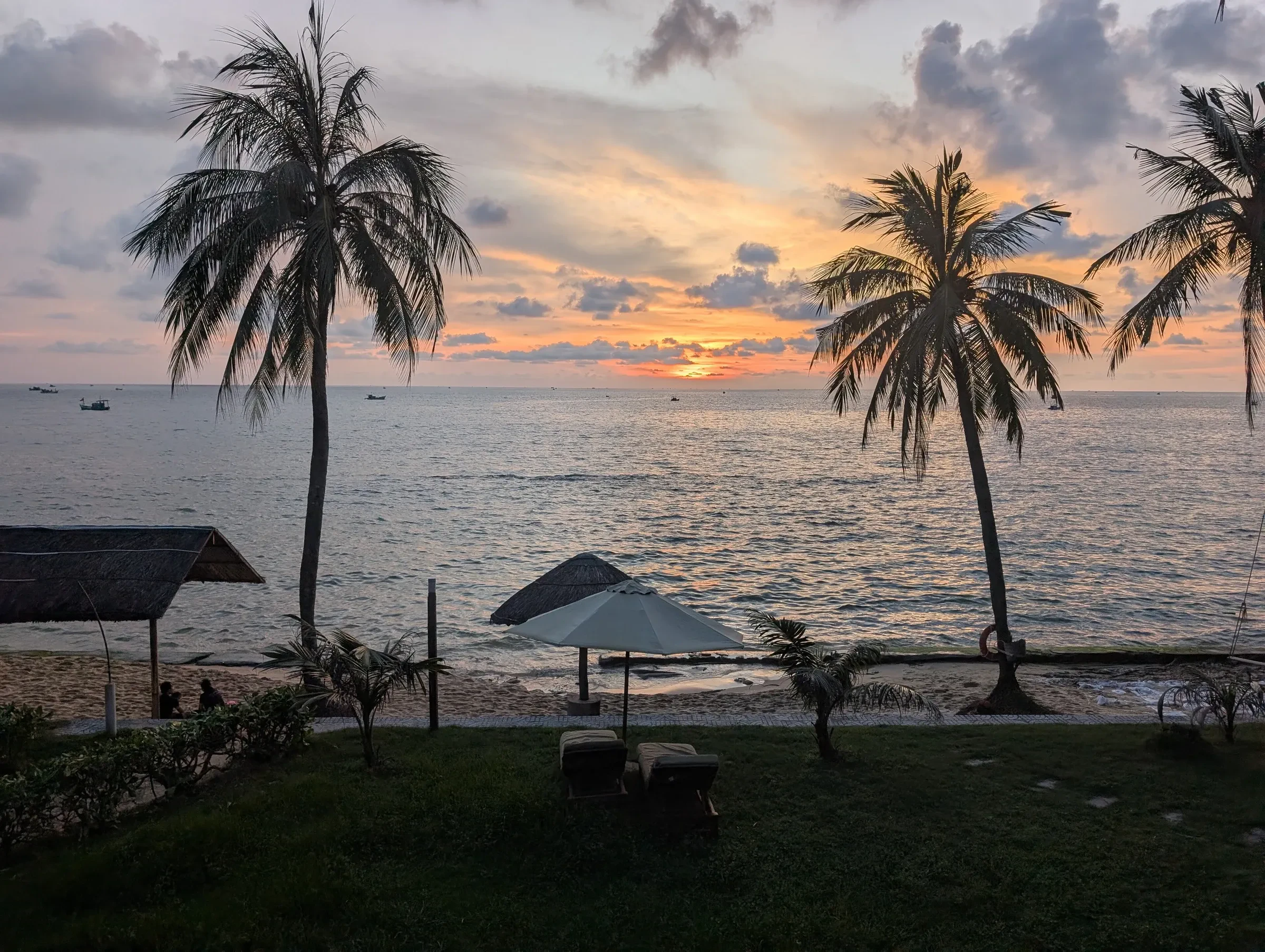 Palm trees against a sunset over the sea on Phu Quoc