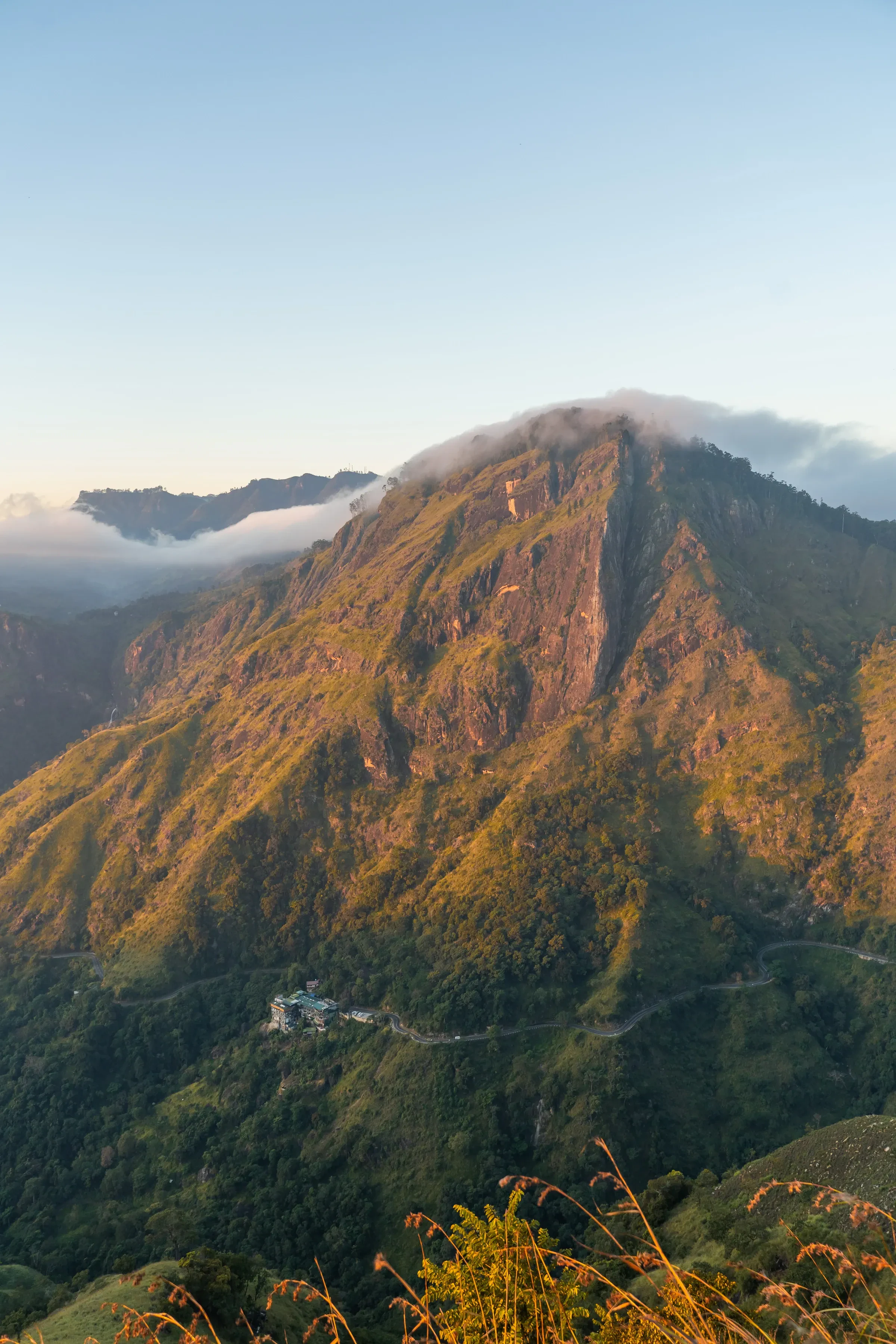 Walkers on the path up Little Adam's Peak near Ella as the sun rises over the hills