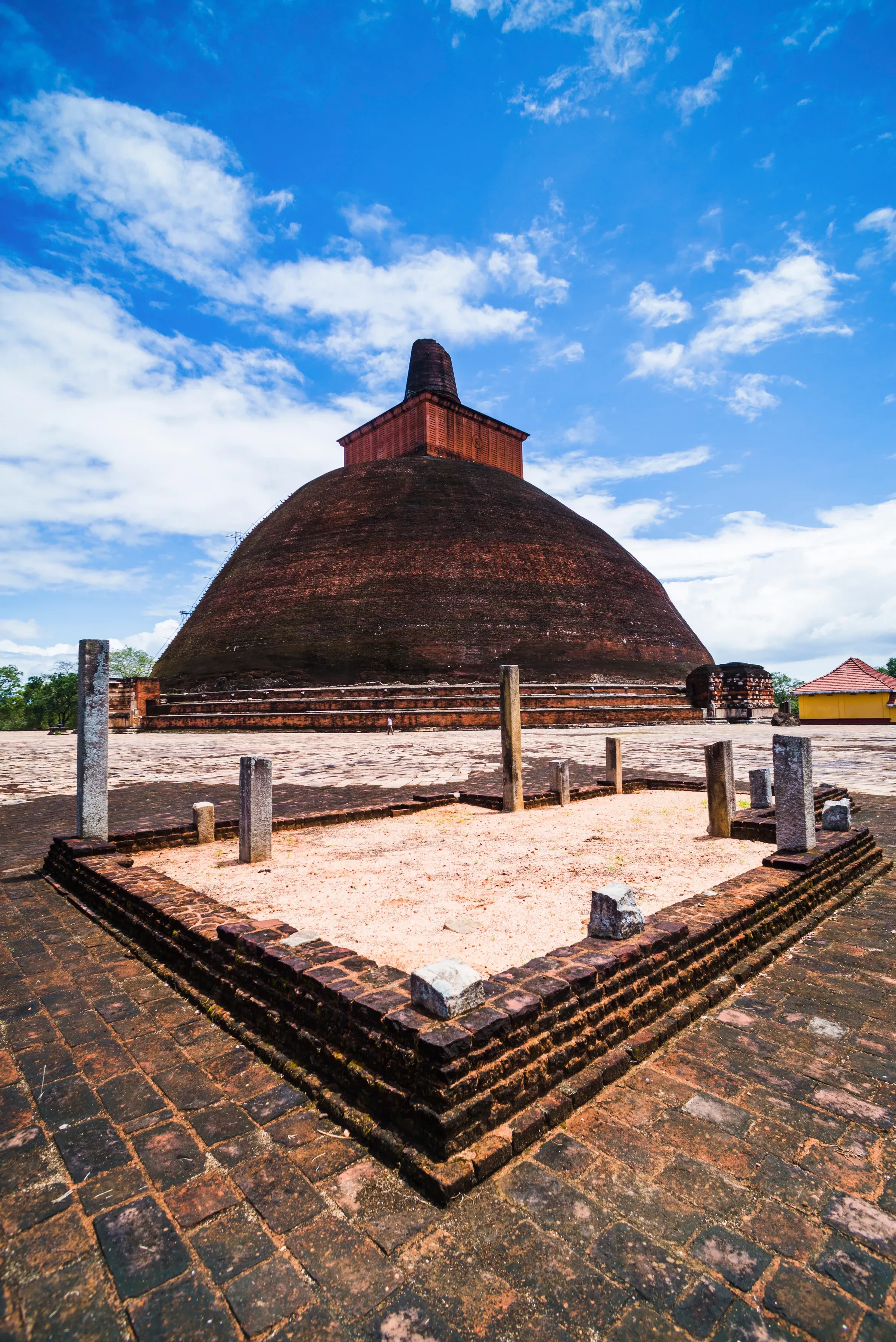 The dome of the Jetavanarama stupa rising above brick paving at Anuradhapura, Sri Lanka