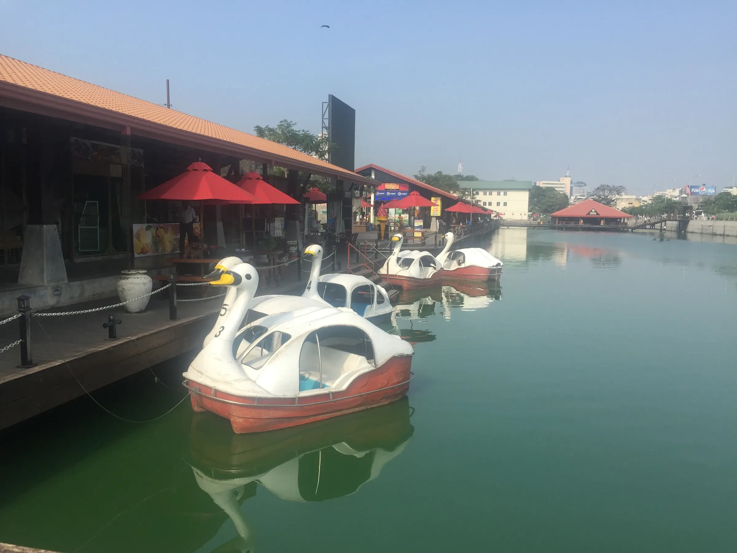 Swan pedal boats and shops at the Pettah Floating Market in Colombo