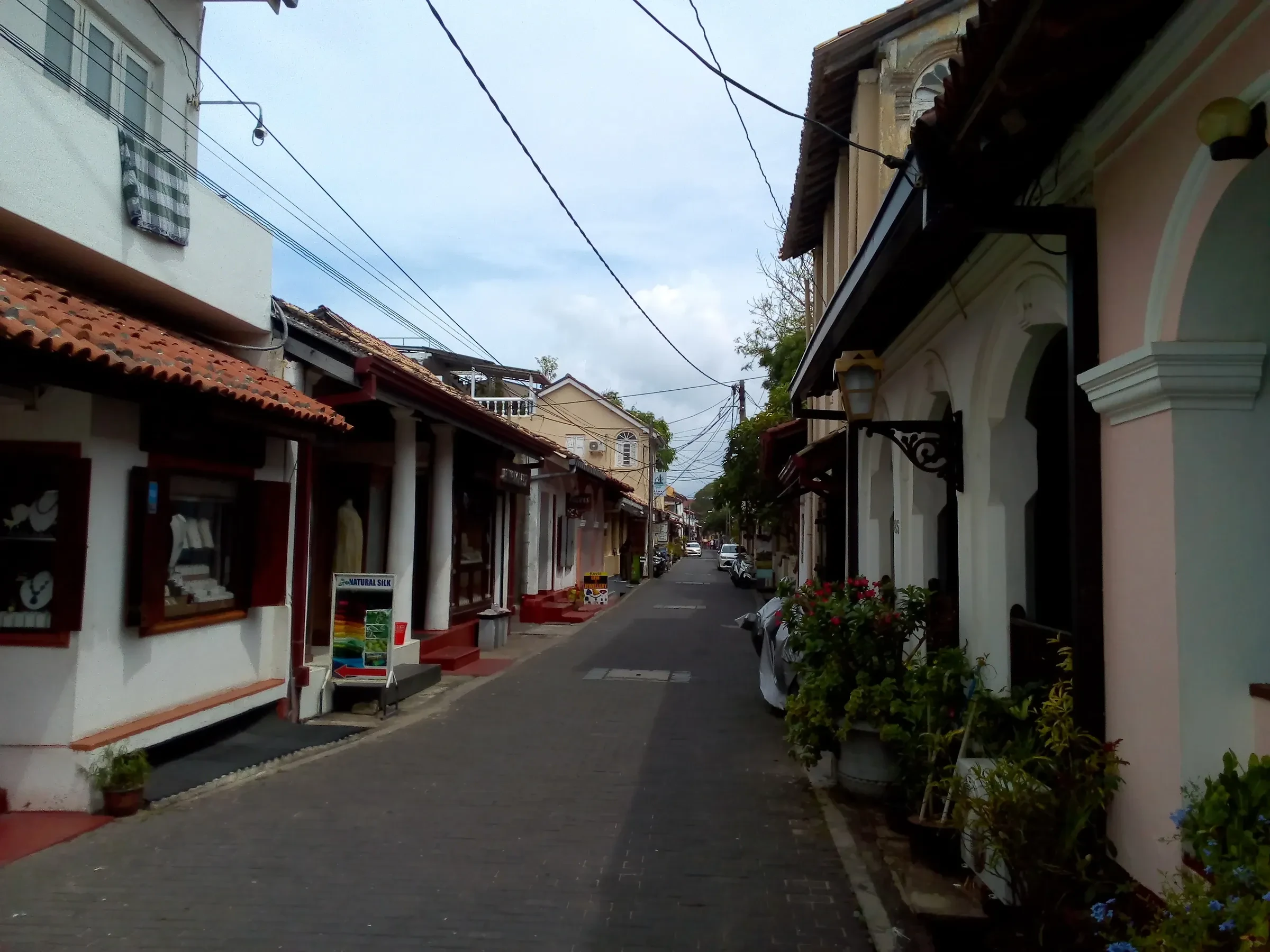A narrow street of colonial-era houses and shopfronts inside Galle Fort