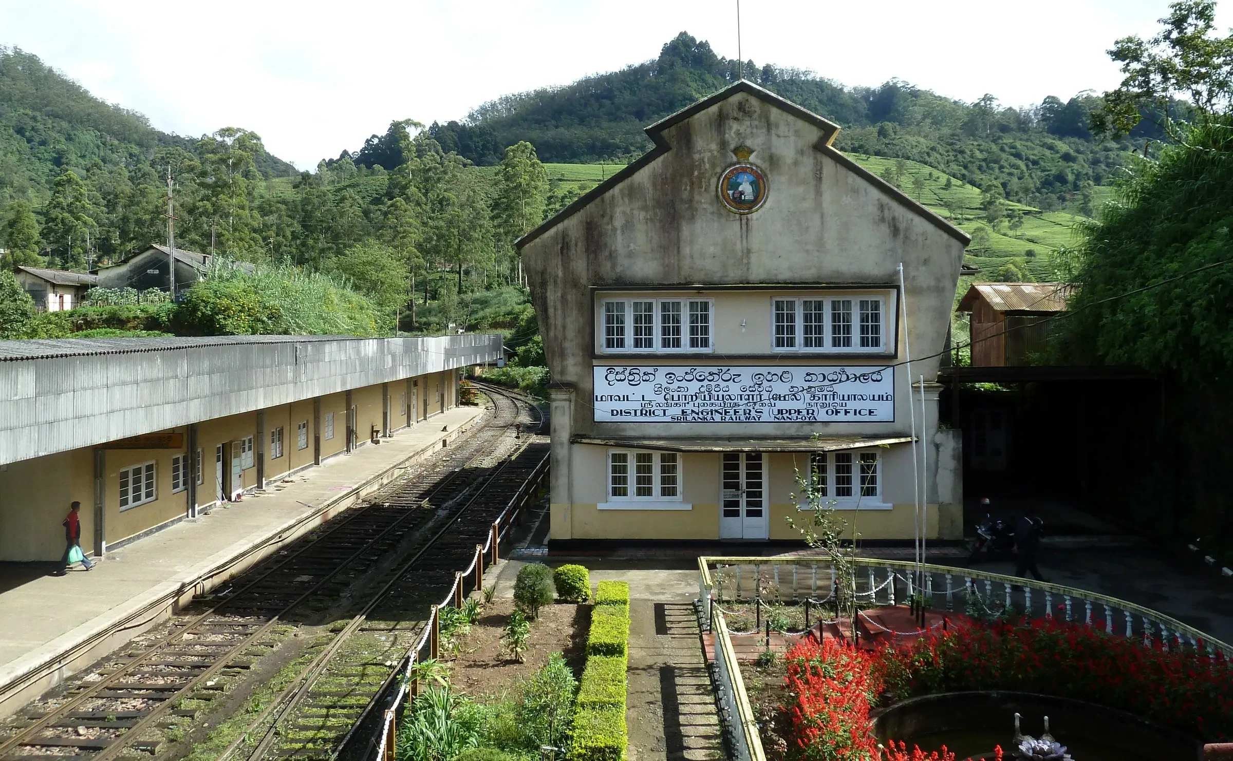 The station building at Nanu Oya with tea hills behind it