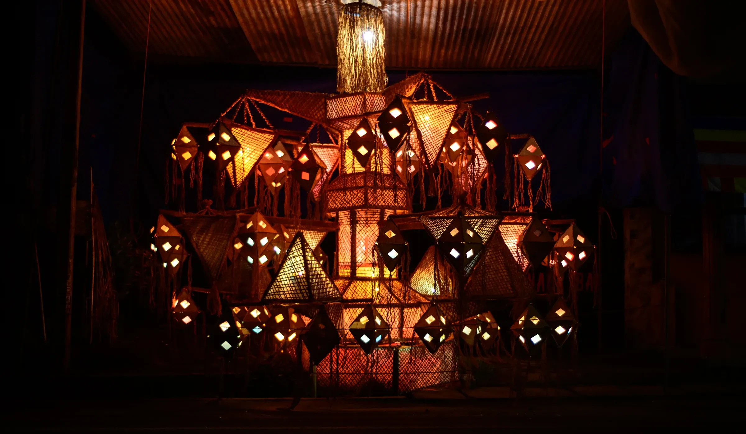 A tiered display of lanterns glowing at night for Vesak in Sri Lanka