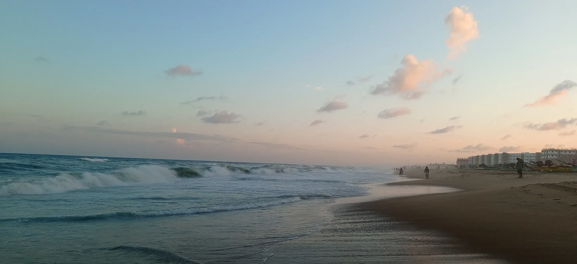 Waves rolling onto Marina Beach in Chennai at dusk