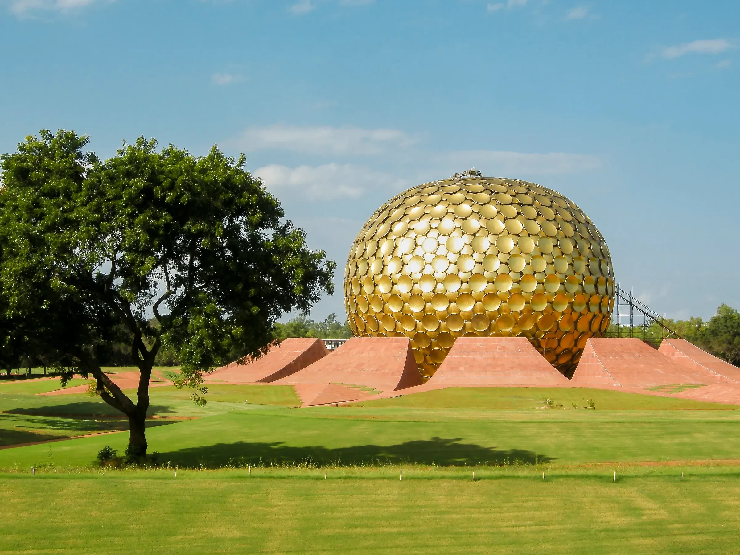 The golden Matrimandir sphere above its gardens in Auroville