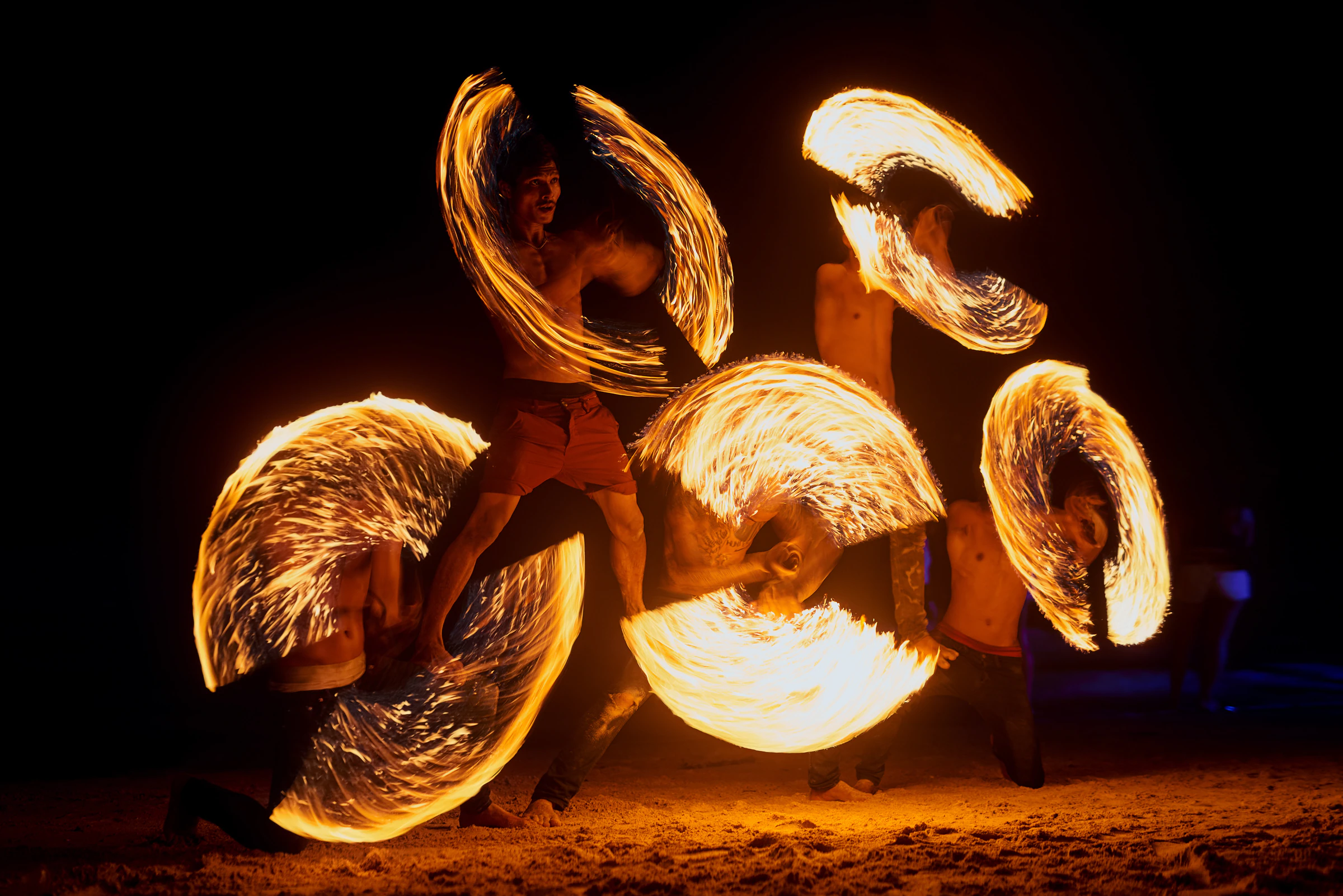 A fire show on a beach at night on a Thai island